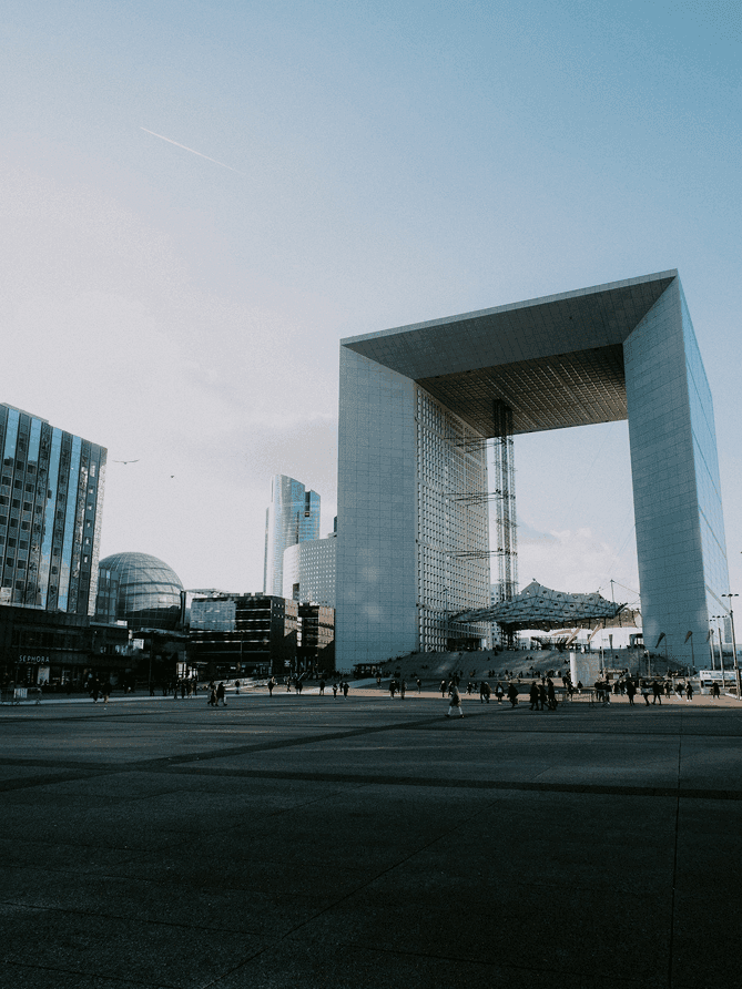 an airplane flying in the sky over a building