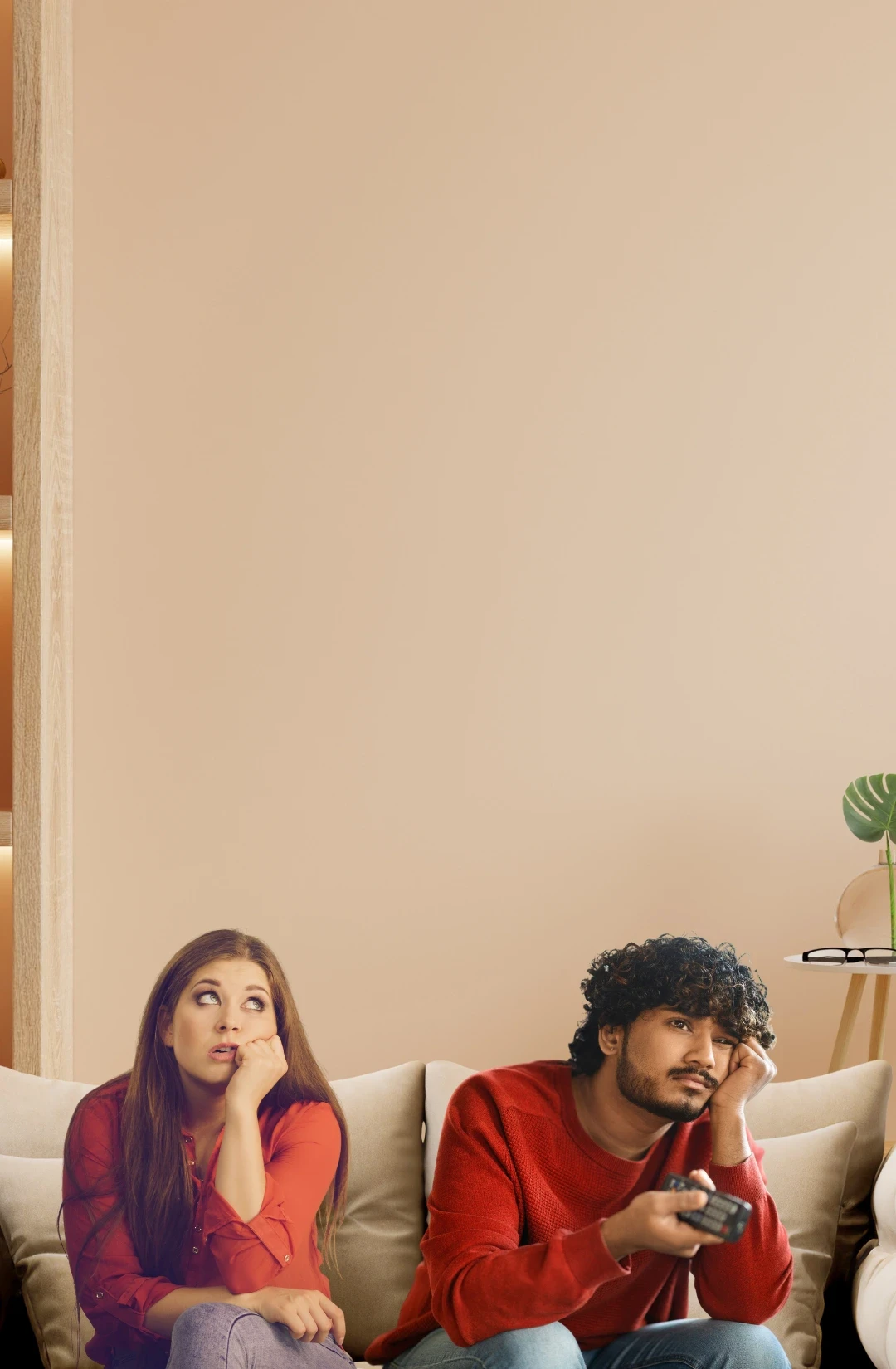 A man and woman in green are having tea at a long dining table