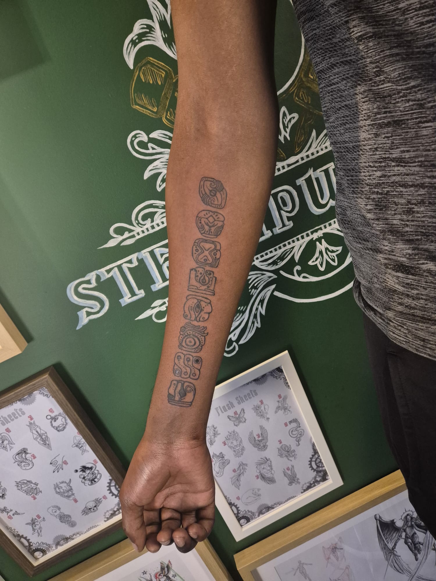 Black and grey forearm tattoo sleeve with ornamental design in Hazel Grove