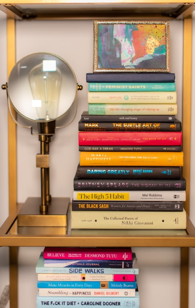 gold bookcase with light and books and light