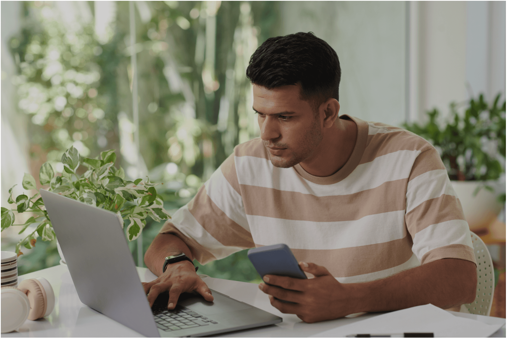 Man on laptop and cellphone