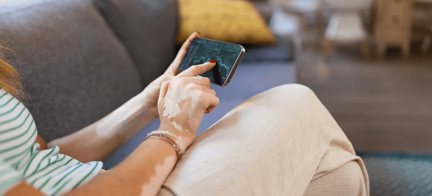 Woman tracking stocks on her phone - How to Buy Crypto Before Listing