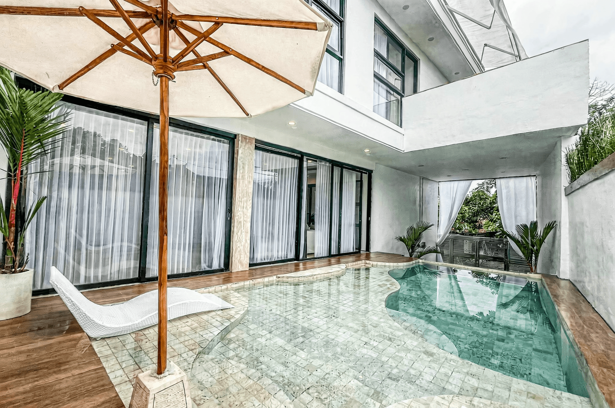Luxury Ungasan I villa exterior with a white sun lounger and private pool, listed by Bali real estate agents.