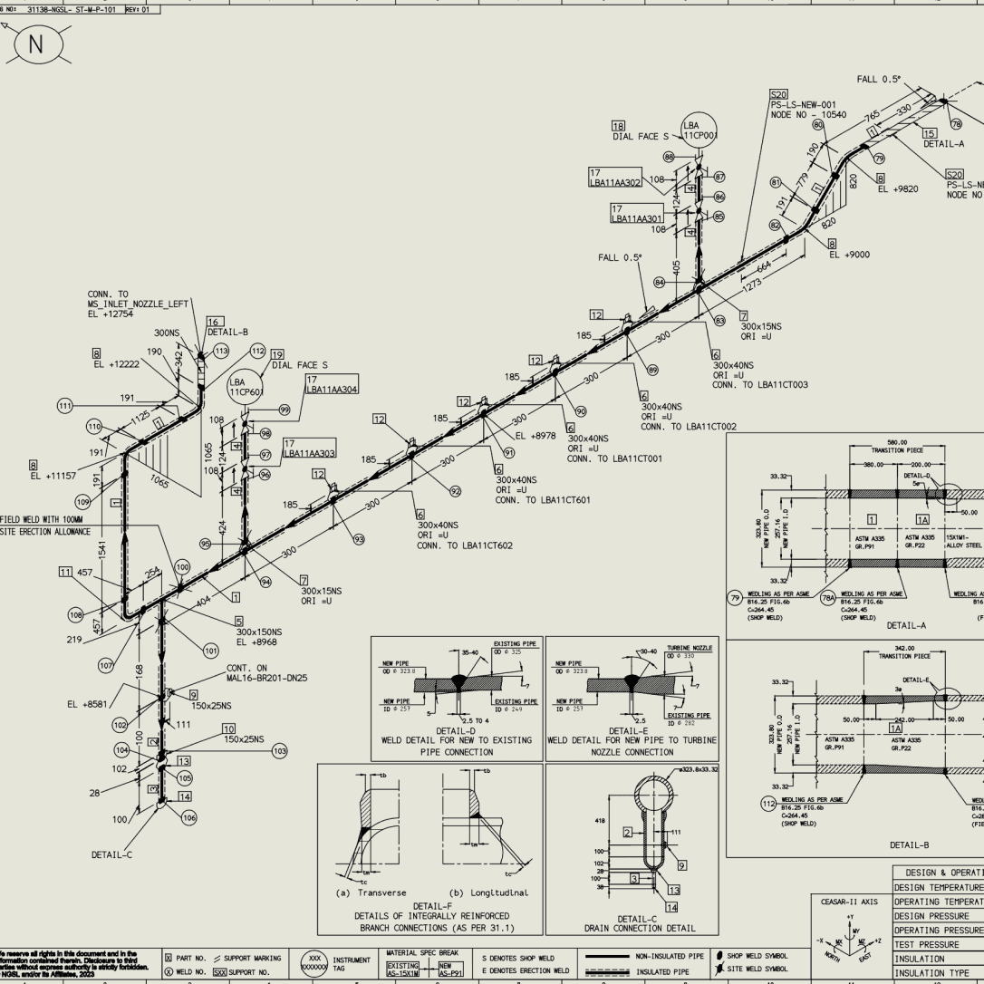Autumn leaves frame modern city buildings under clear sky.