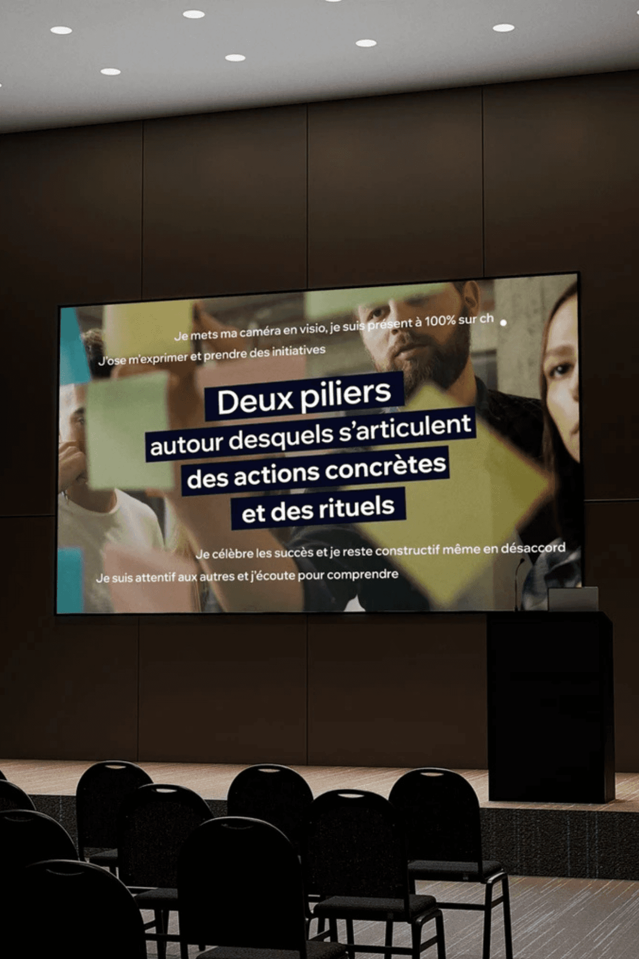 Skis and poles rest against a wooden fence in a snowy landscape. Sunlight filters through trees, creating a peaceful, warm glow.