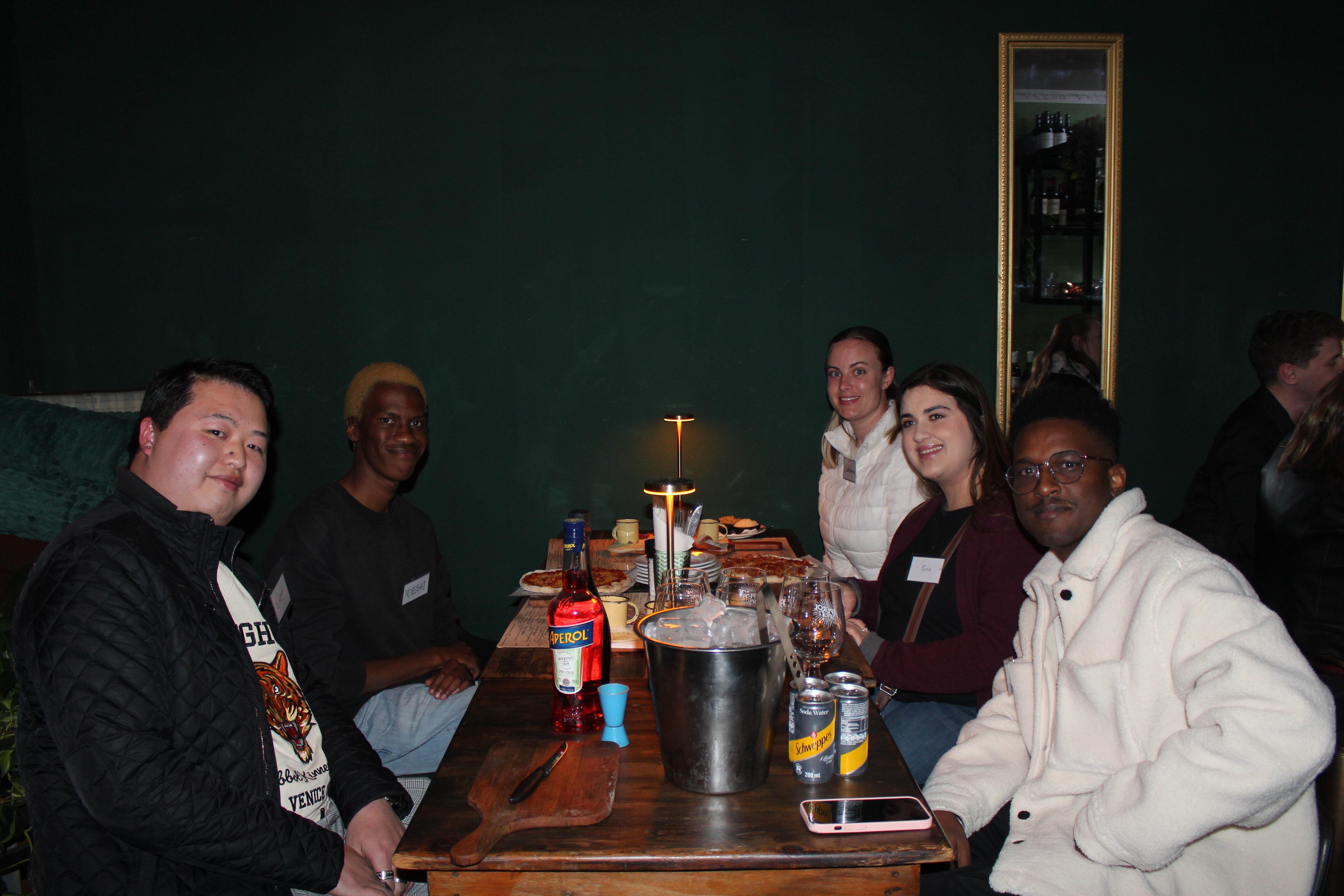 Group of people smiling and having a conversation