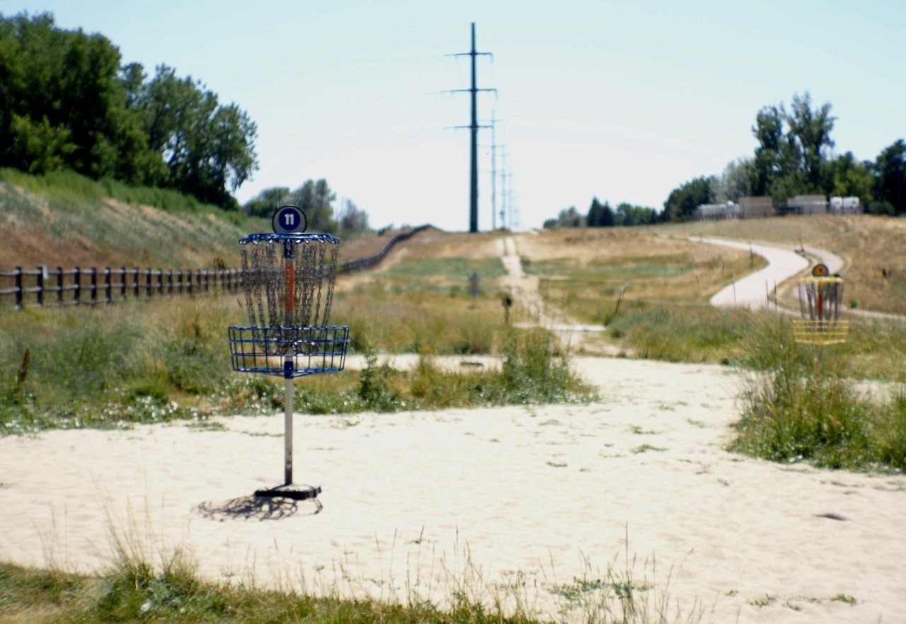 A dirt path through an open grassy field in West Side Fort Collins.