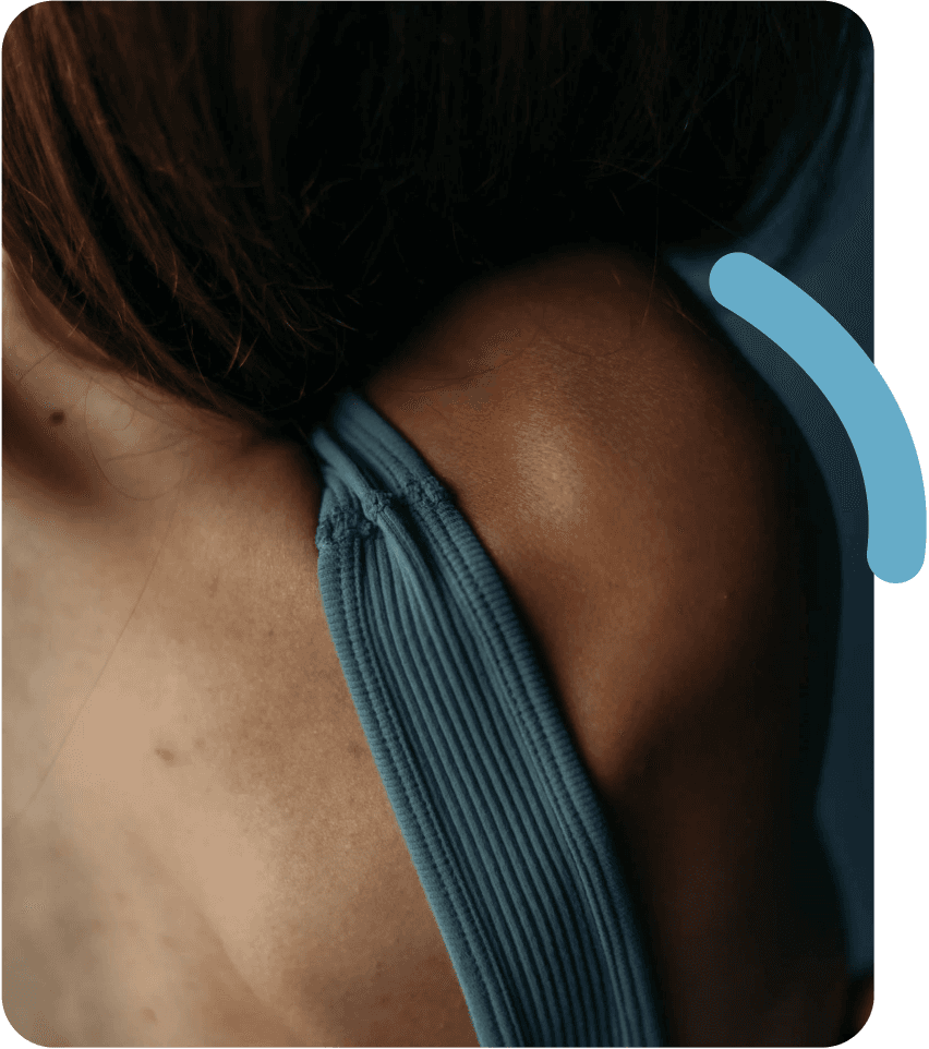 Close-up of a female's body wearing a teal dress with open back.