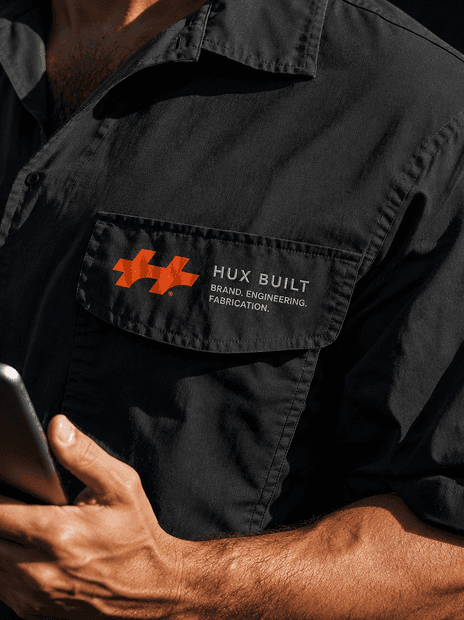 Black industrial sensor device with small photo of man working at computer