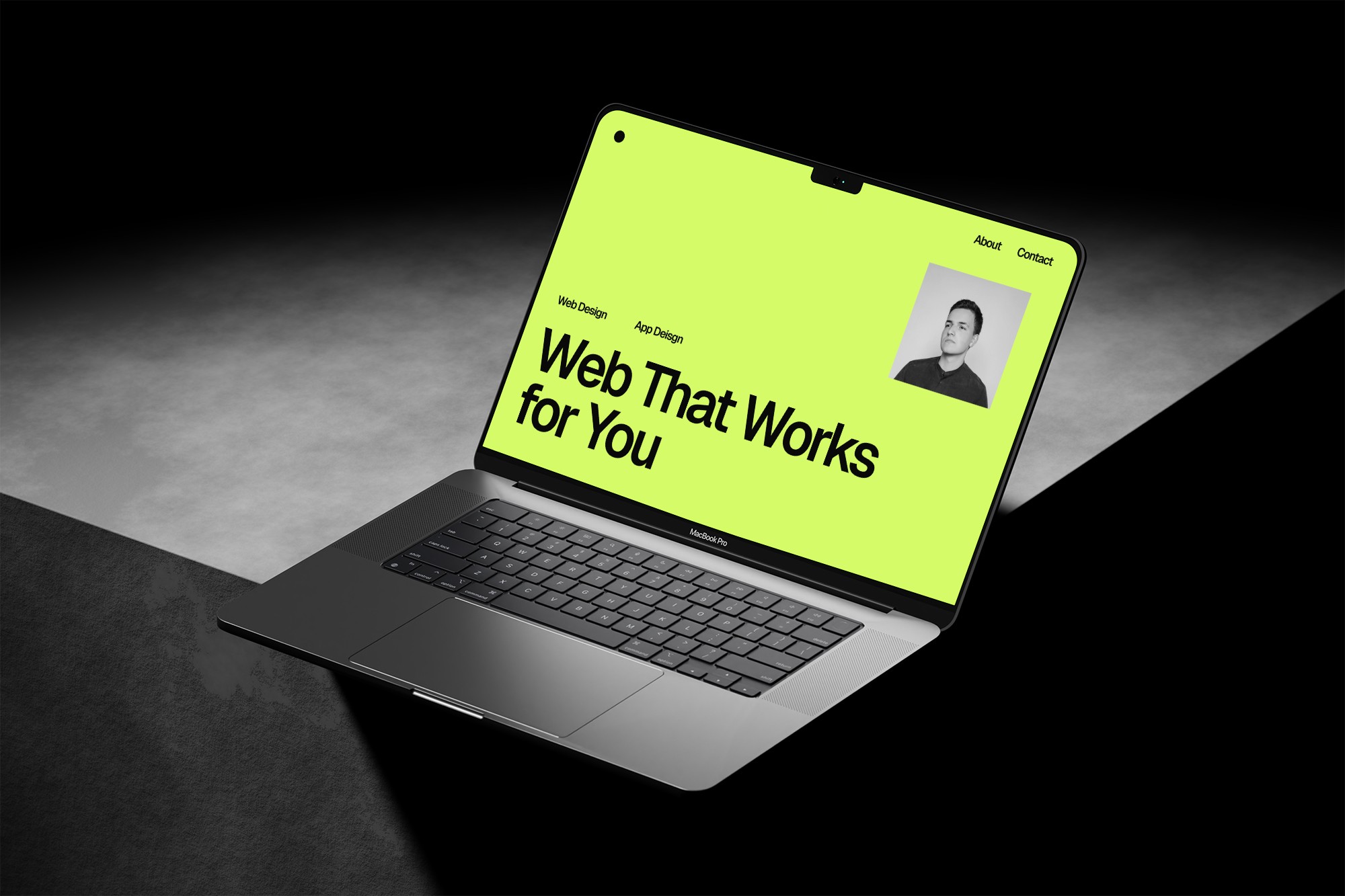 Laptop on concrete, website on screen