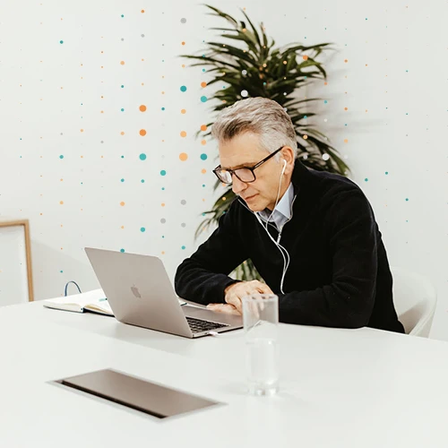 consultant sat in a meeting with laptop and headphones
