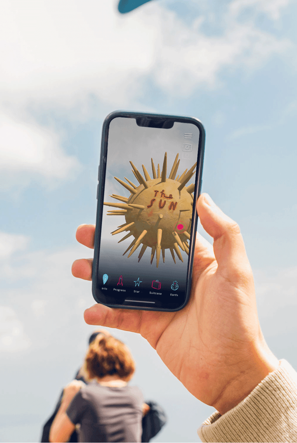 Designer using a laptop to review prototype screens for the Locker Room digital platform.