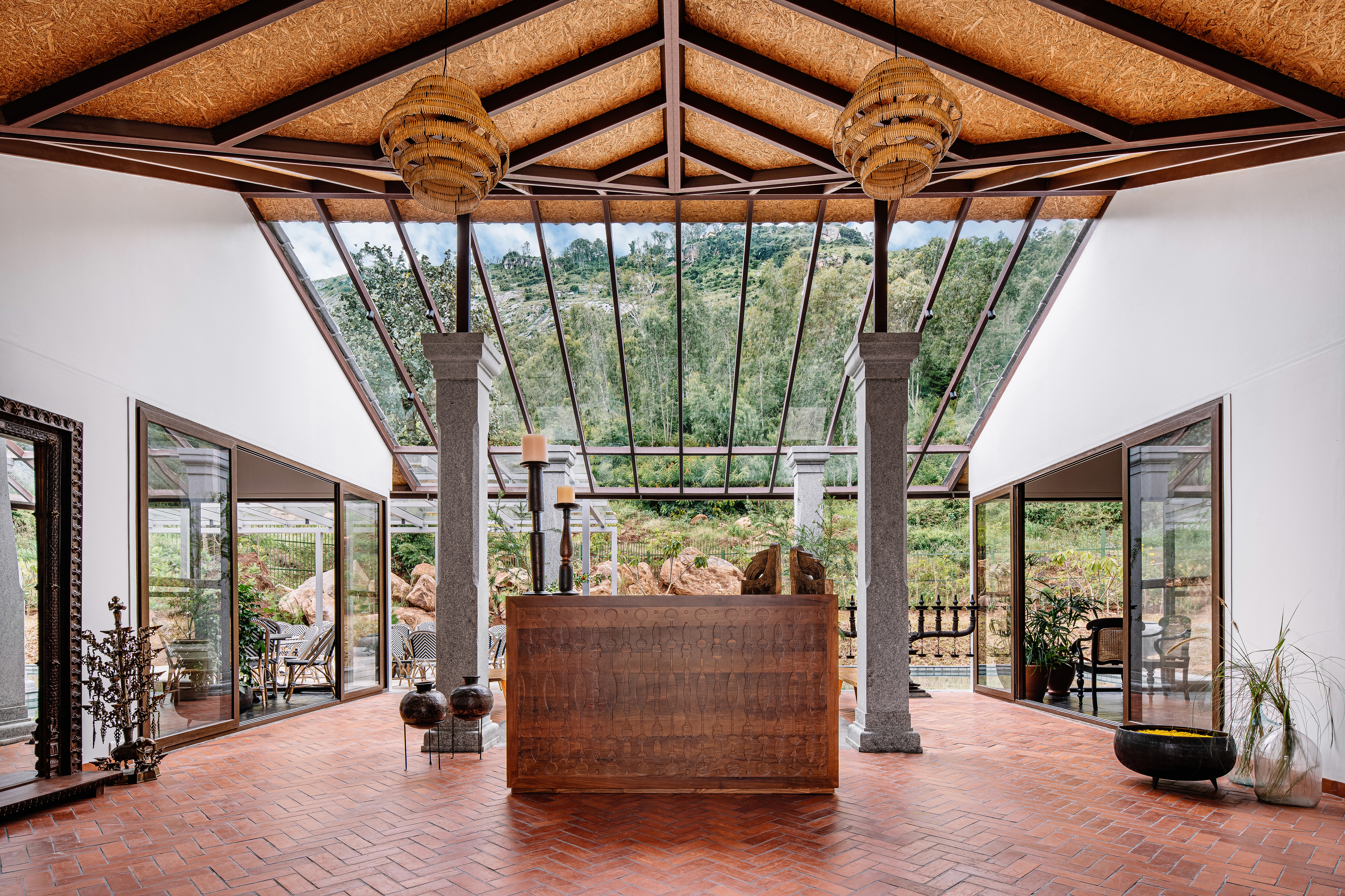 Minimalist pavilion with a perforated roof casting shadows on the white courtyard below.