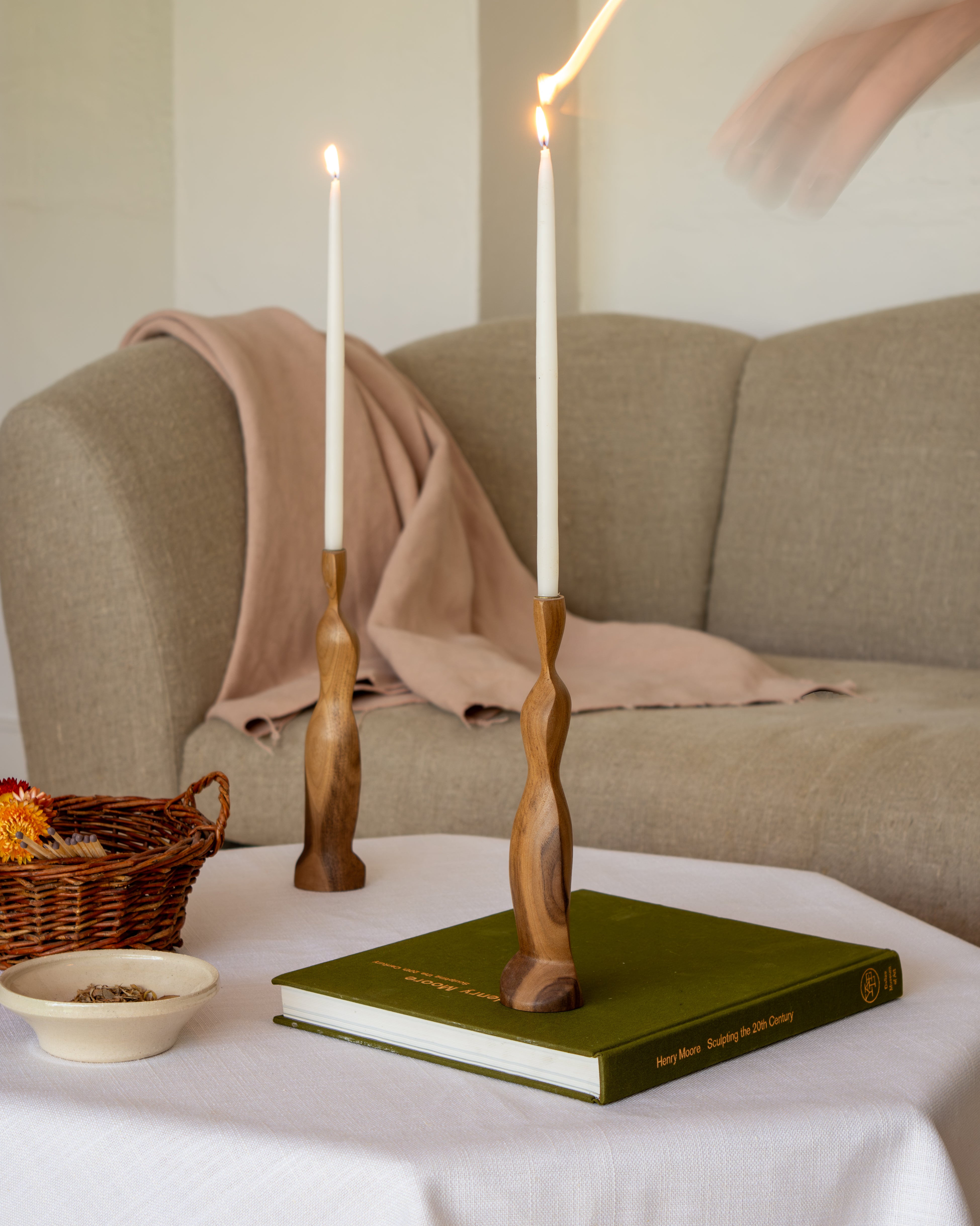 Figura Candlestick holders in Walnut with Bay Sofa and book