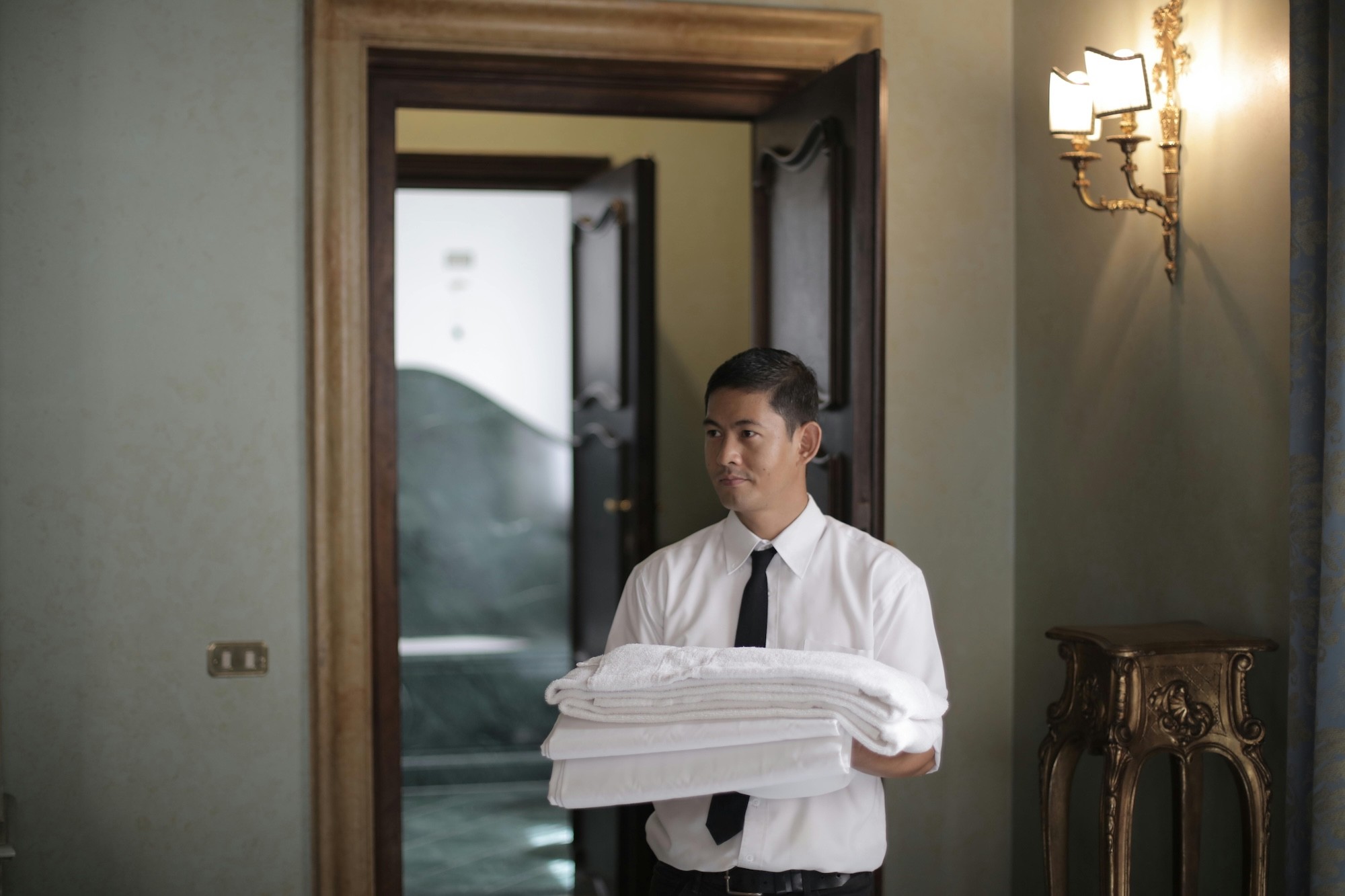 Hotel staff holding towels
