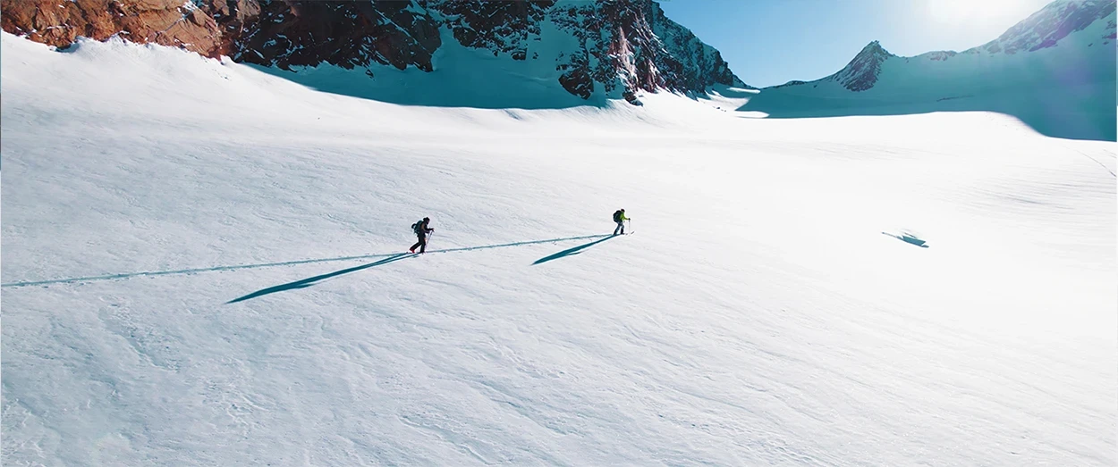 Two people walking on big white field