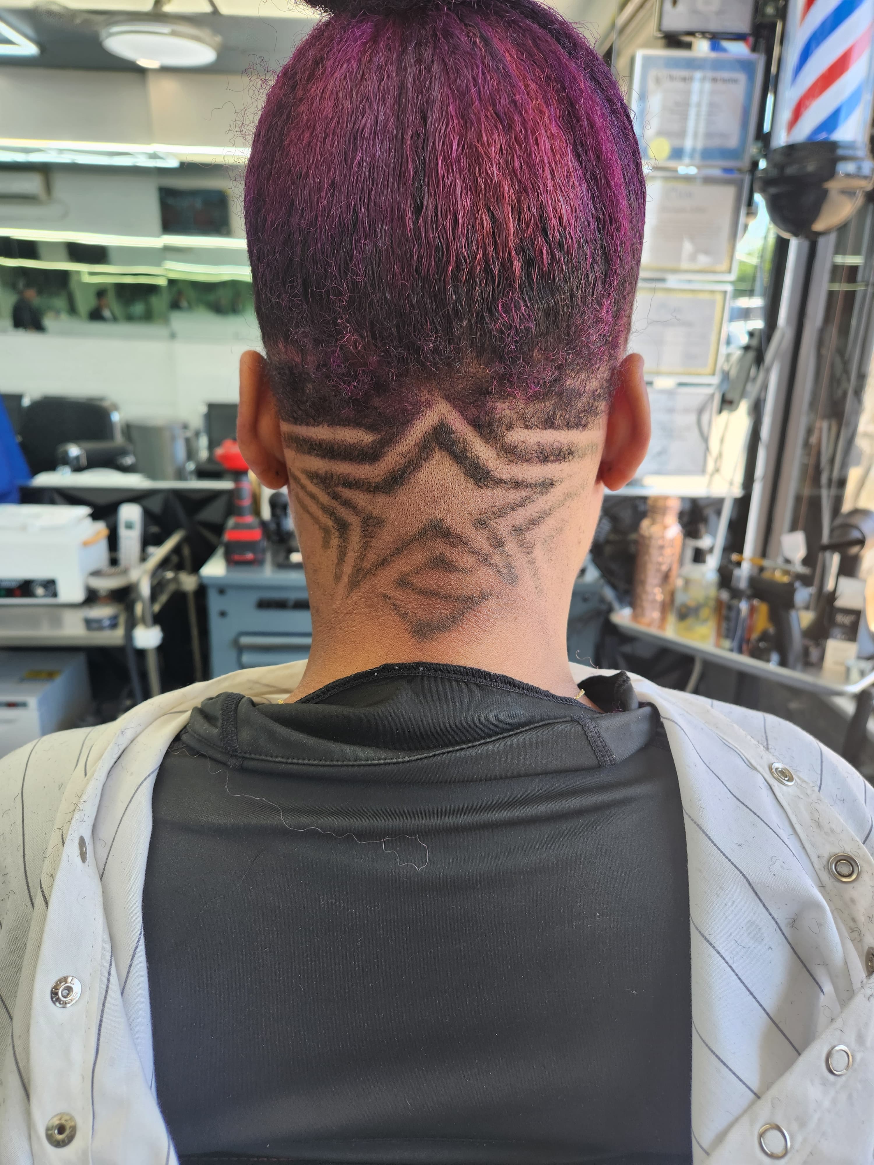 Barber posing with razor and scissor