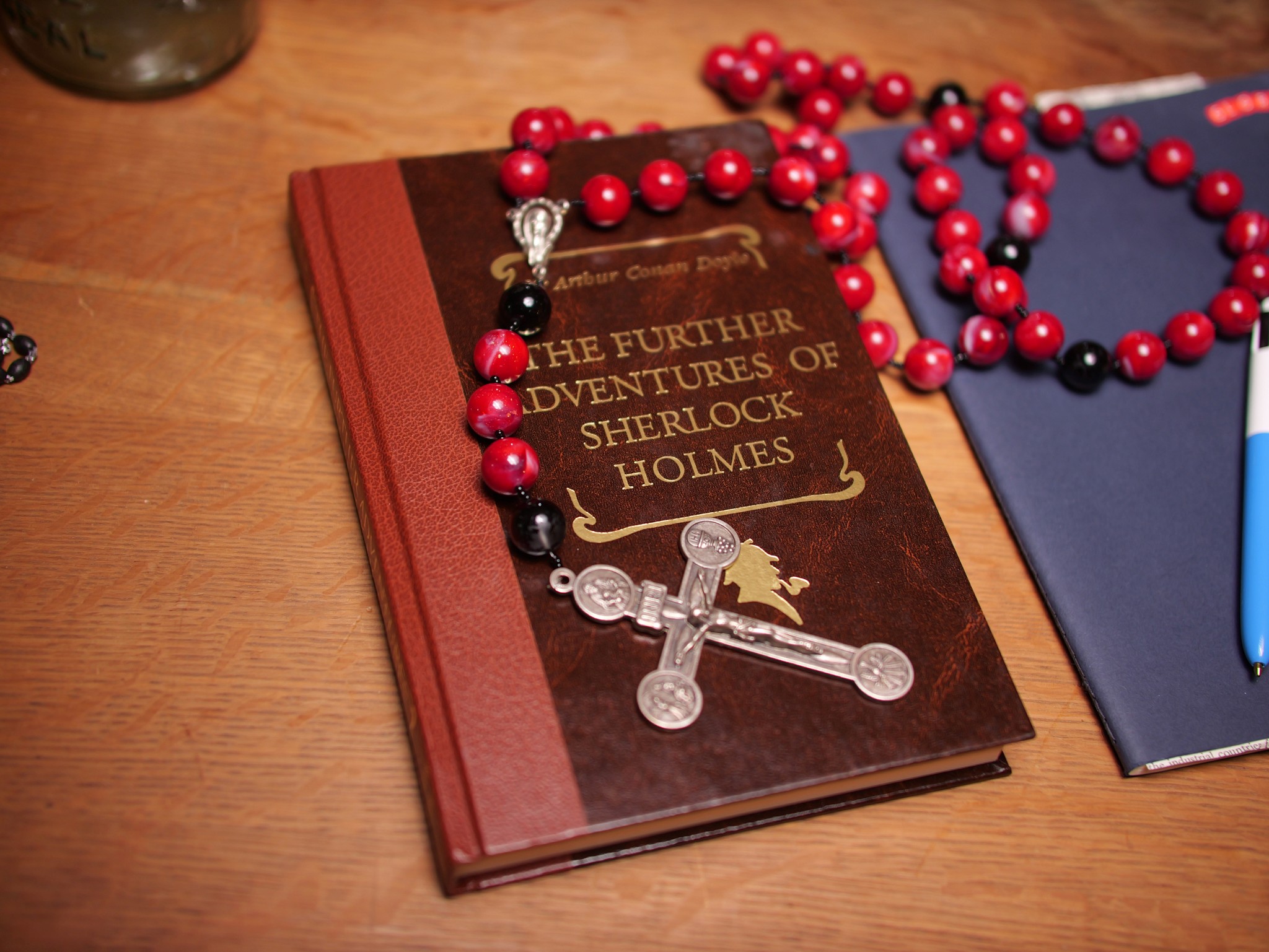Dirt road flanked by vineyards and cypress trees, rolling hills, mist, and distant town in Tuscany.