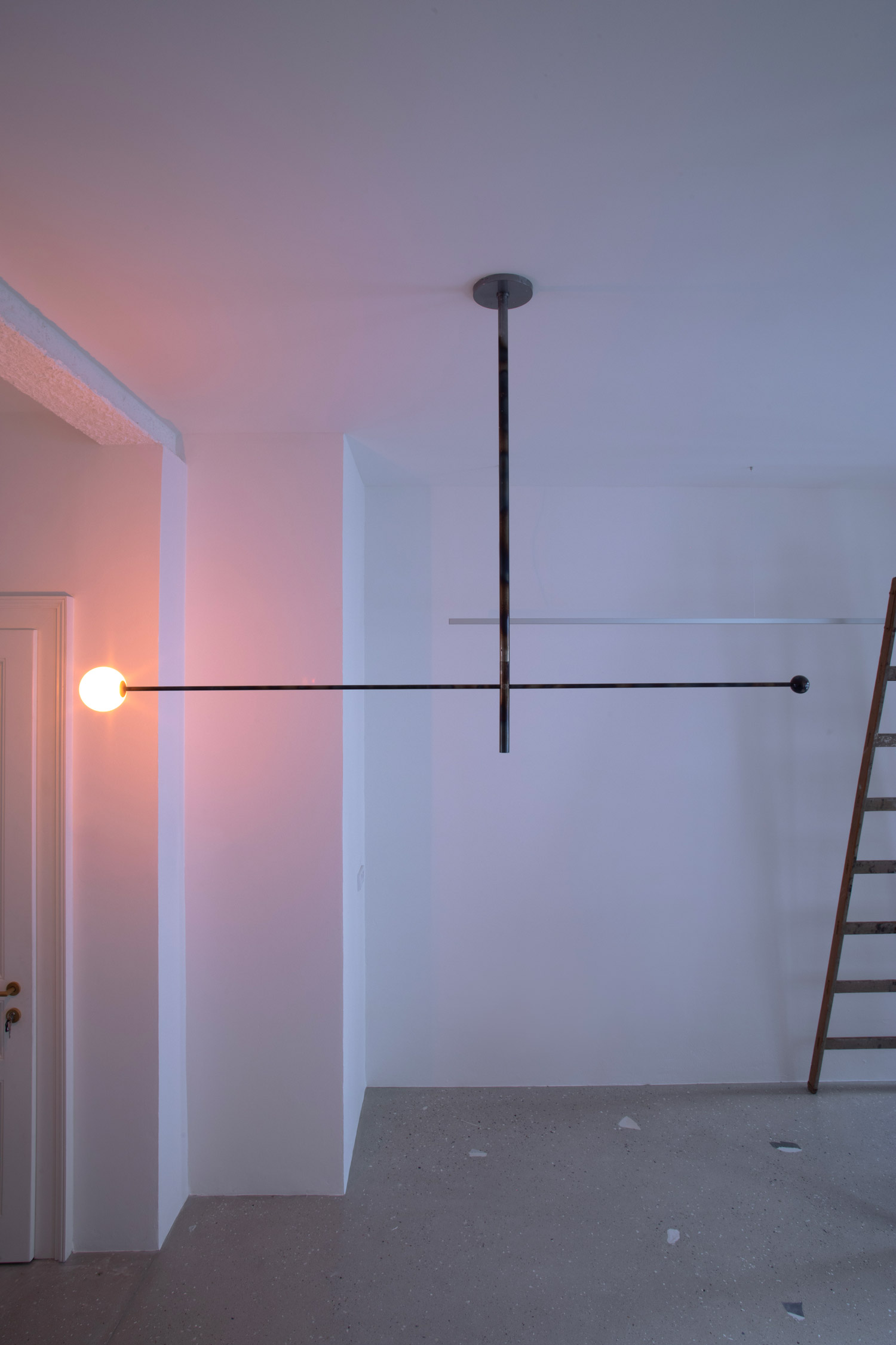 Luna Orbit swivel ceiling luminaire installed in interior space creating directional lighting effect by Jiri Krejcirik