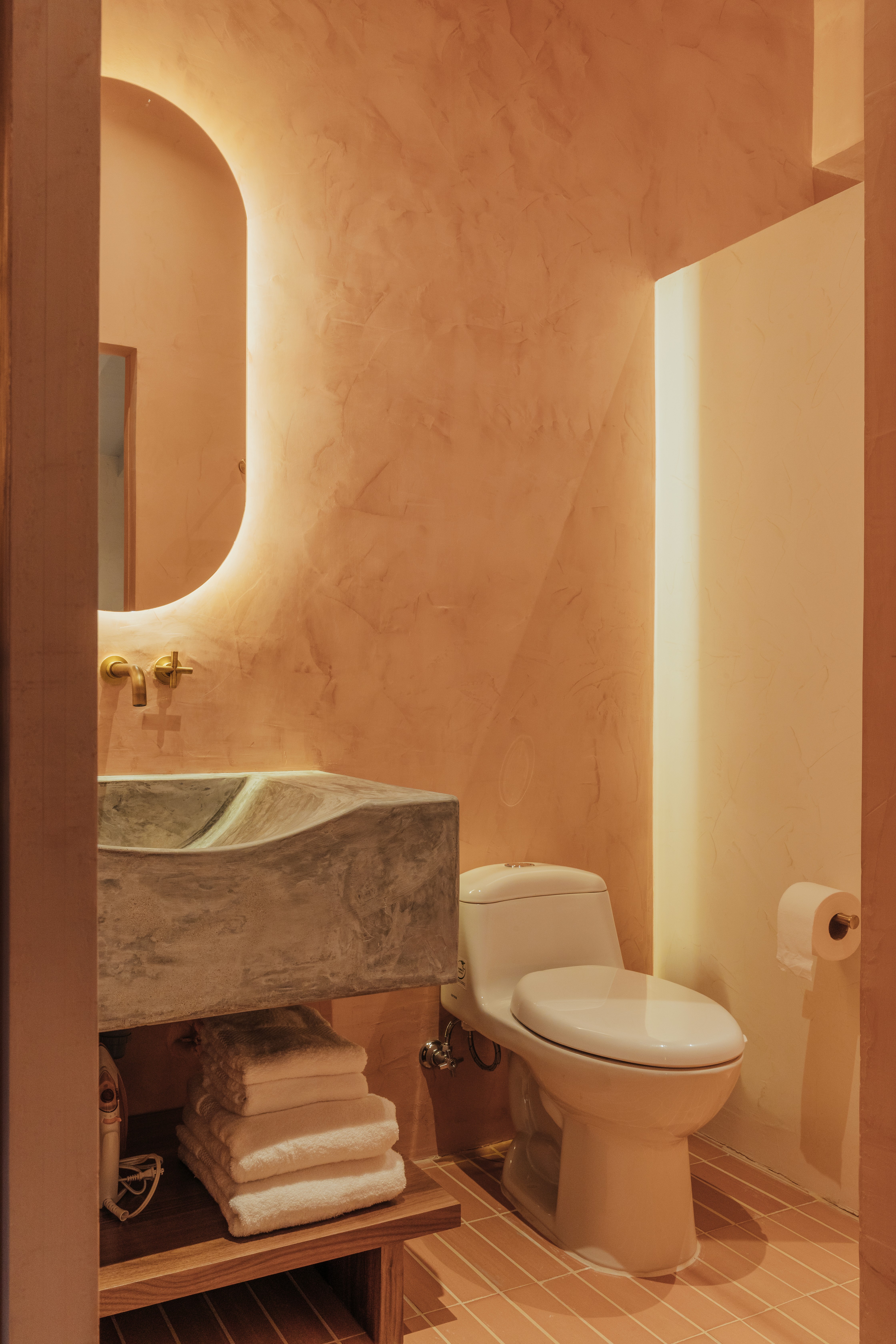 Double-height interior with flowing sculptural forms and warm raking light