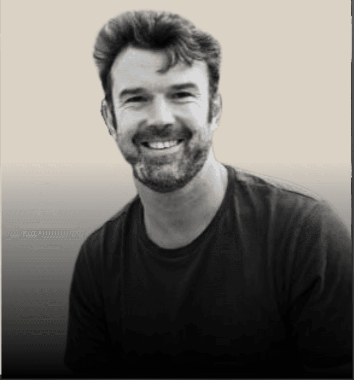 headshot of male in dark background