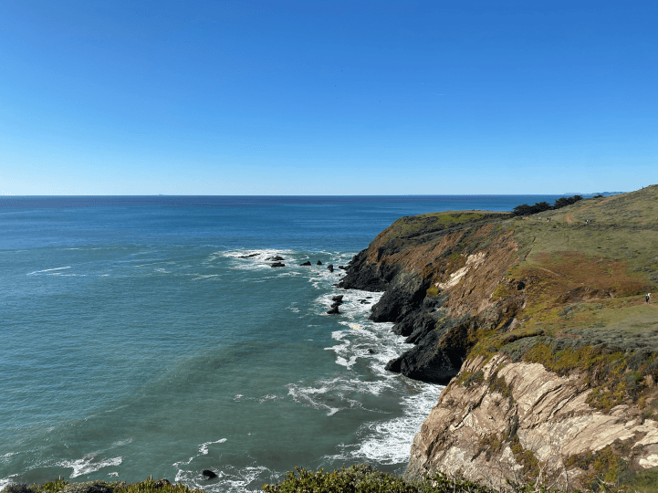 a group of people walking on a sidewalk