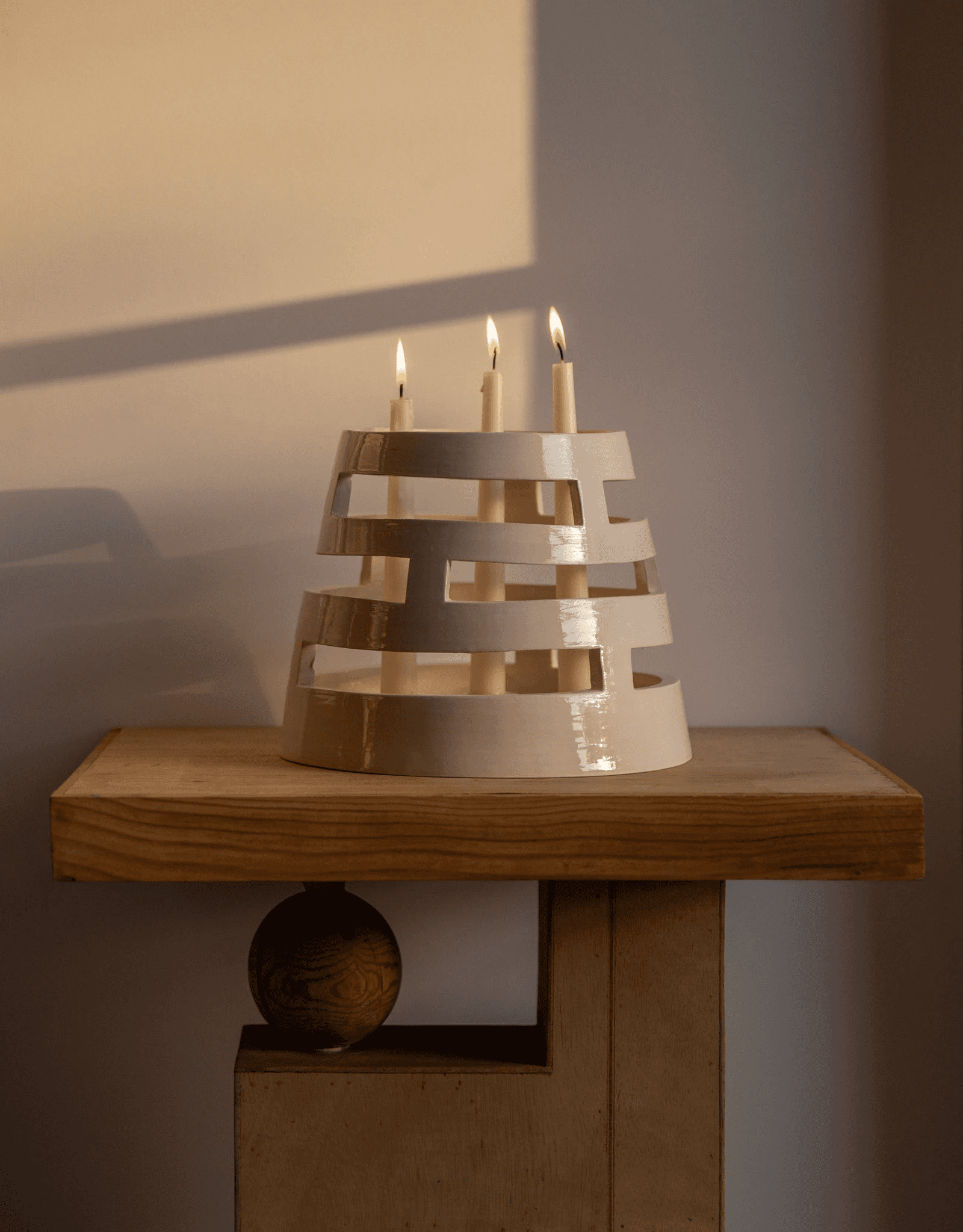 Garado Studios W59 candle holder with lit candles on a wooden table