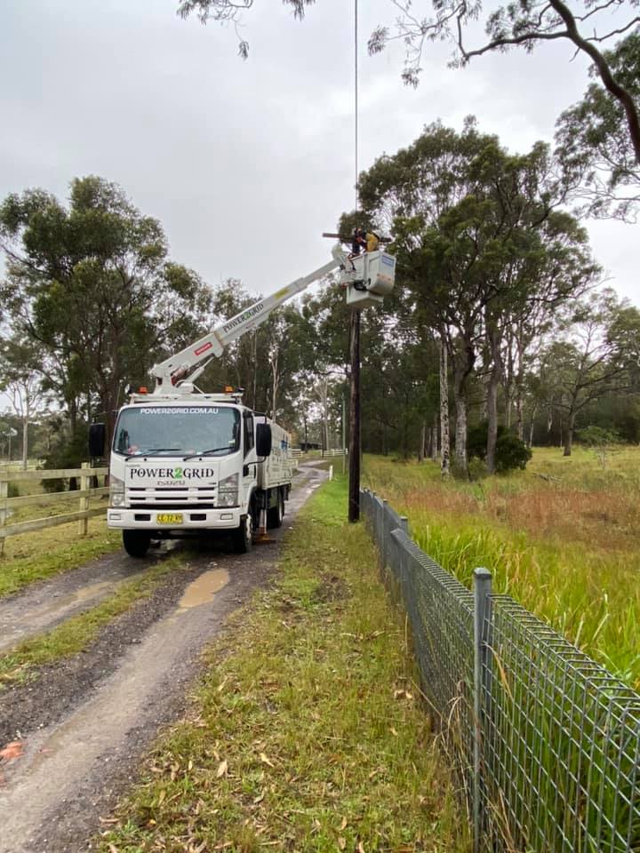 An image of Power2grid Truck working on an electric pole