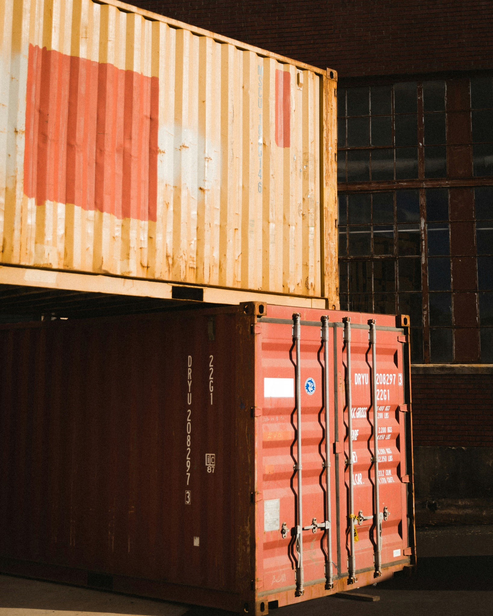 a crane is on top of a large stack of containers
