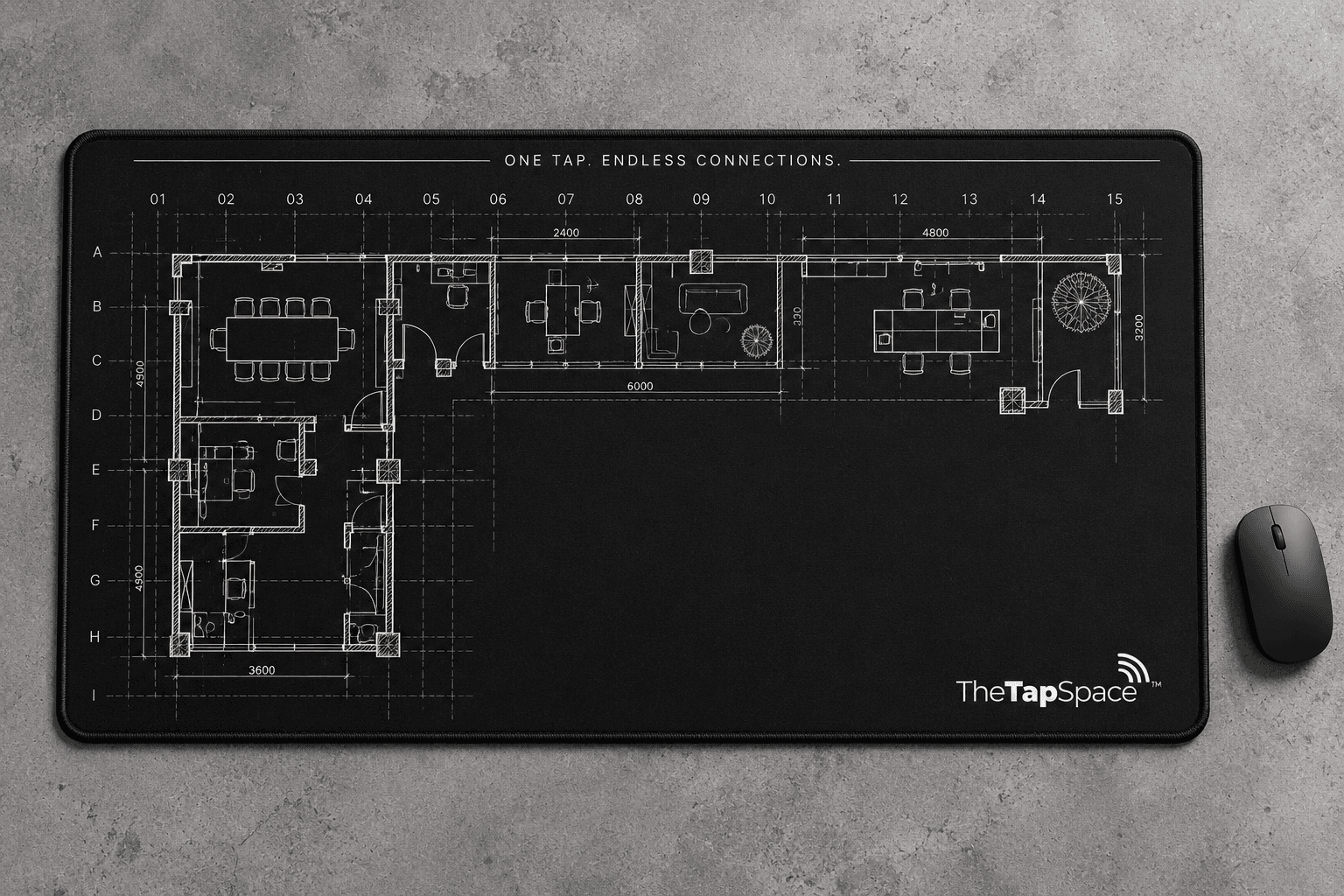 Black desk mat with architectural plan and TheTapSpace mark