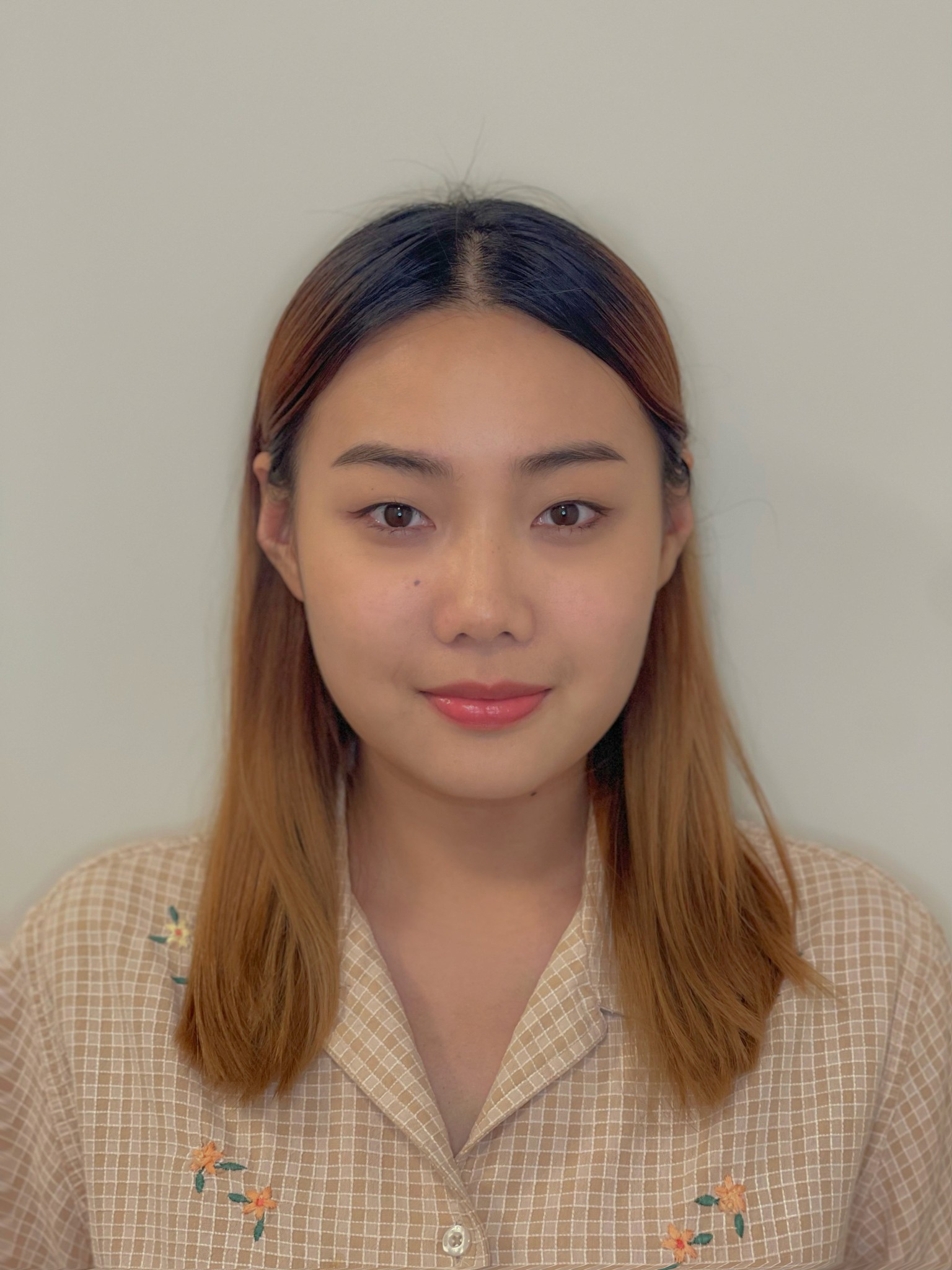 Headshot of a woman with long hair, Emily Jing