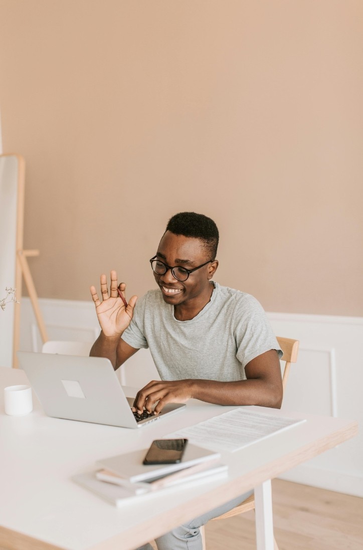woman sitting around table holding tablet