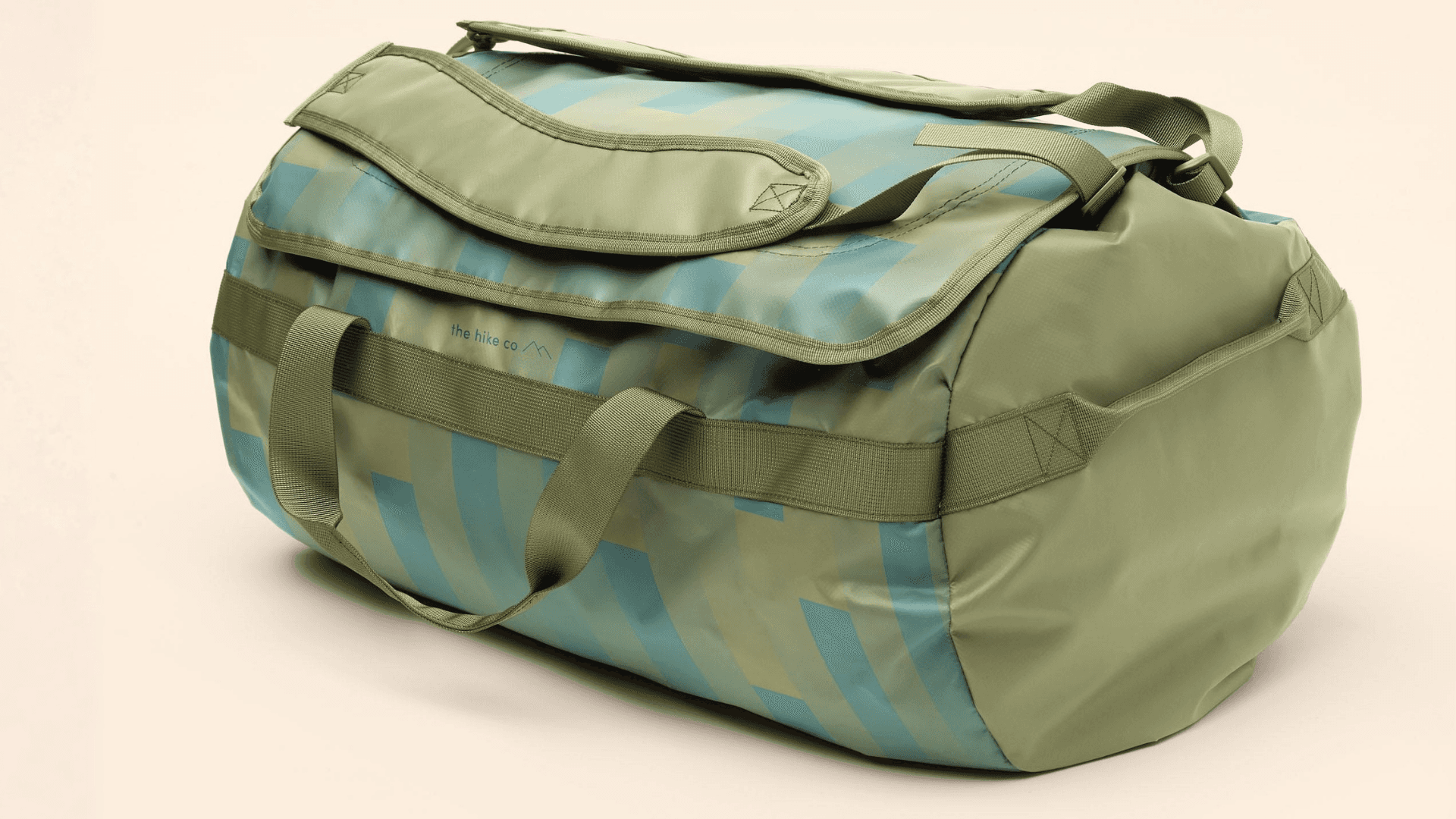 A green and teal backpack duffel on a tan background.