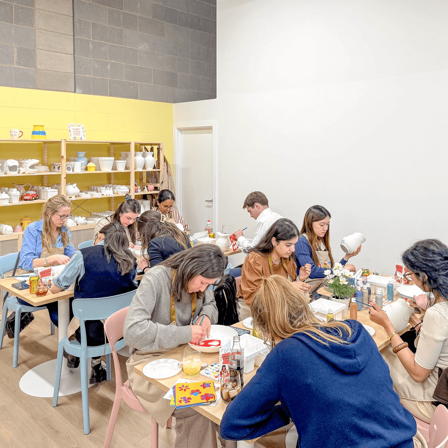 Colleagues enjoying a team building pottery painting workshop in London