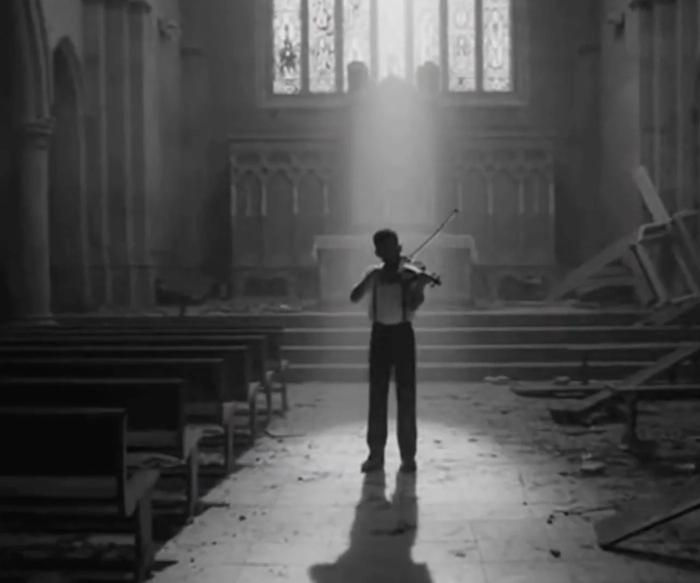 Young violinist beneath a shaft of light in a monochrome church, Strings Noir