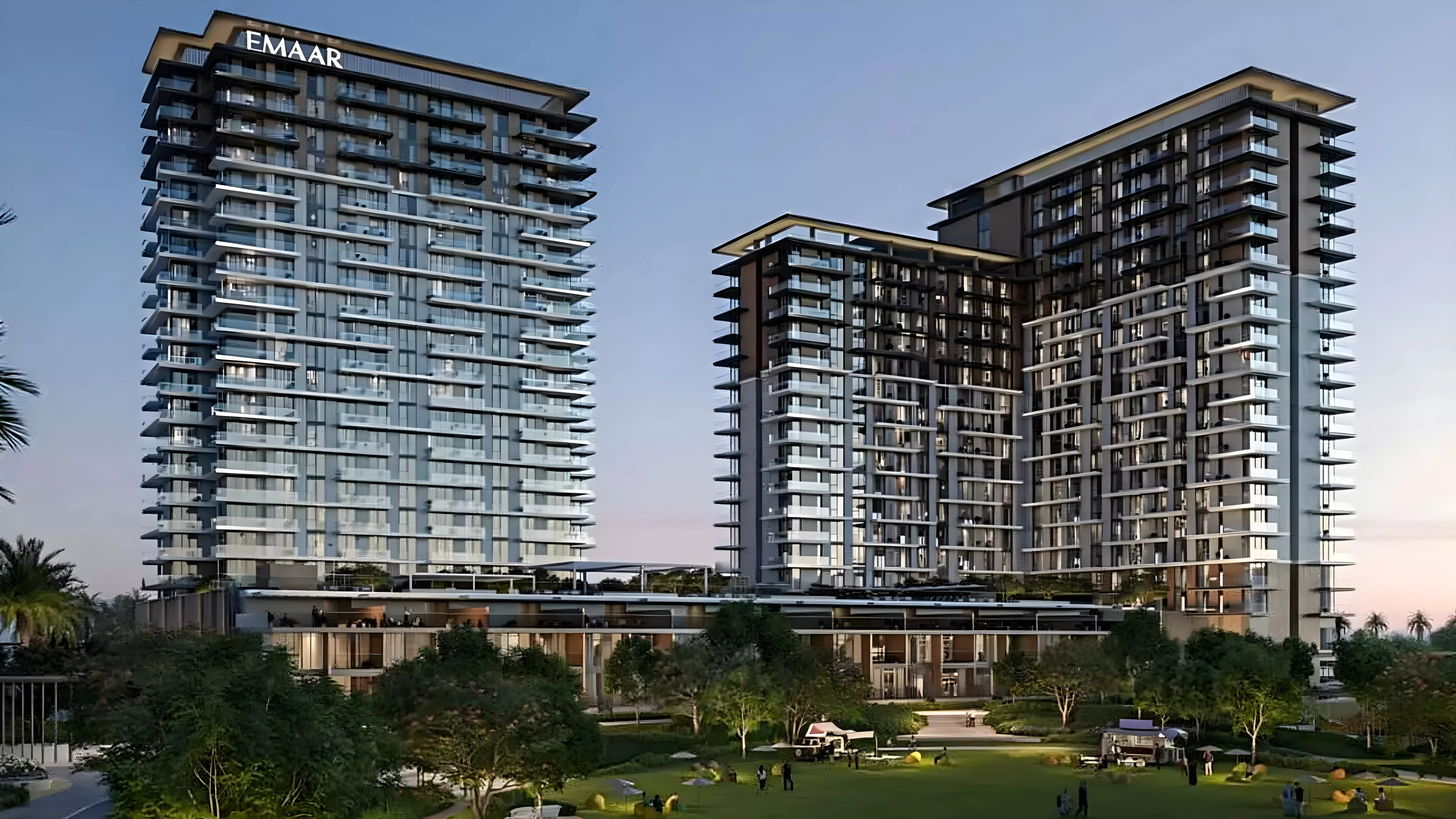 Modern twin towers of Emaar Parkwood with landscaped gardens and evening skyline view in Dubai