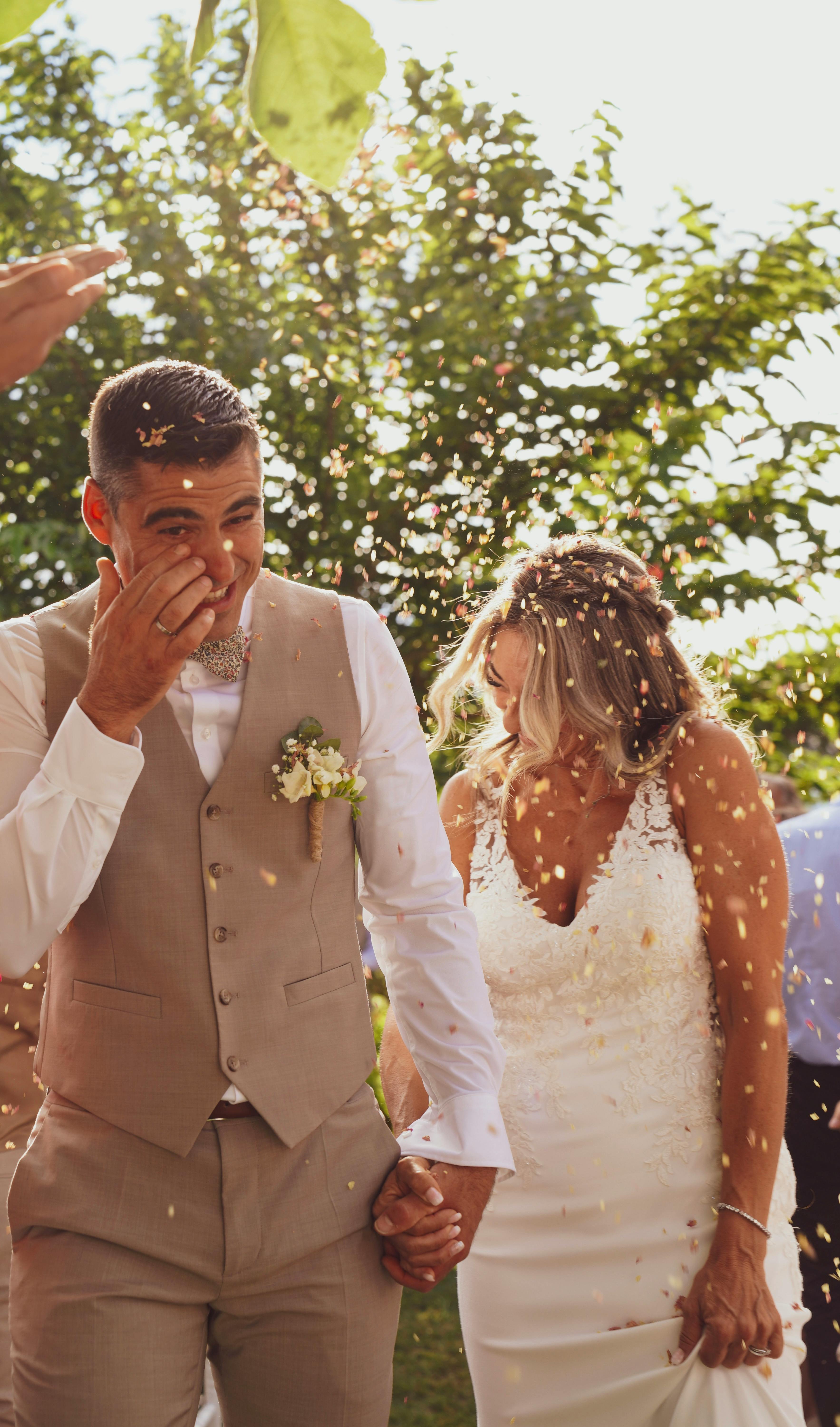 A couple embraces lovingly on a wooden dock.