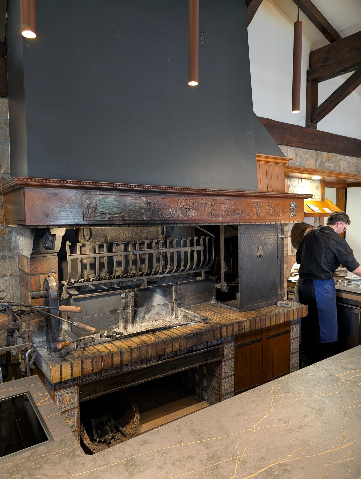 Rocky cove with clear blue water and green cliffs under a sunny sky.