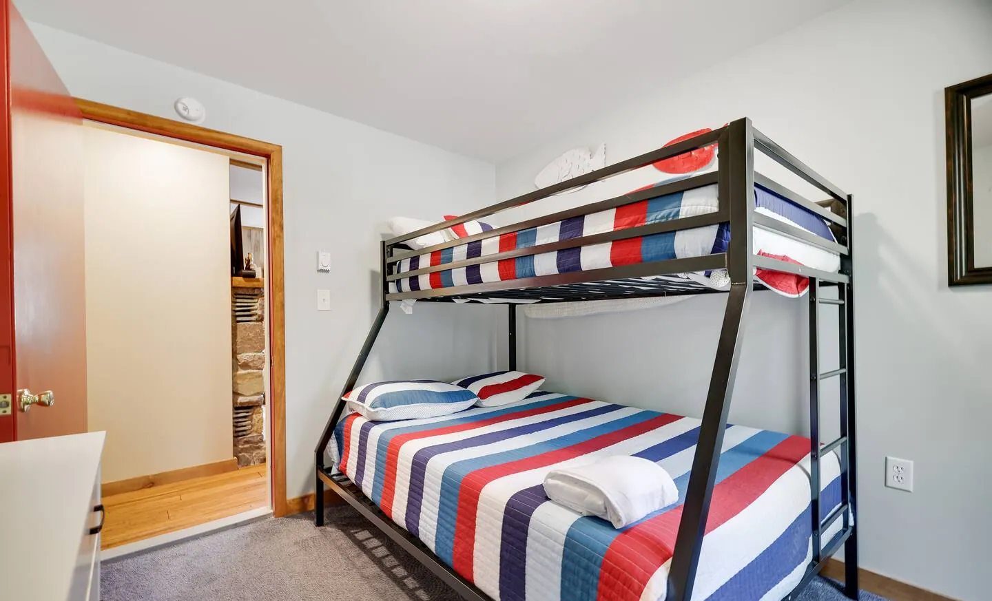 Twin over full bunk bed with striped bedding at RedHawk Chalet