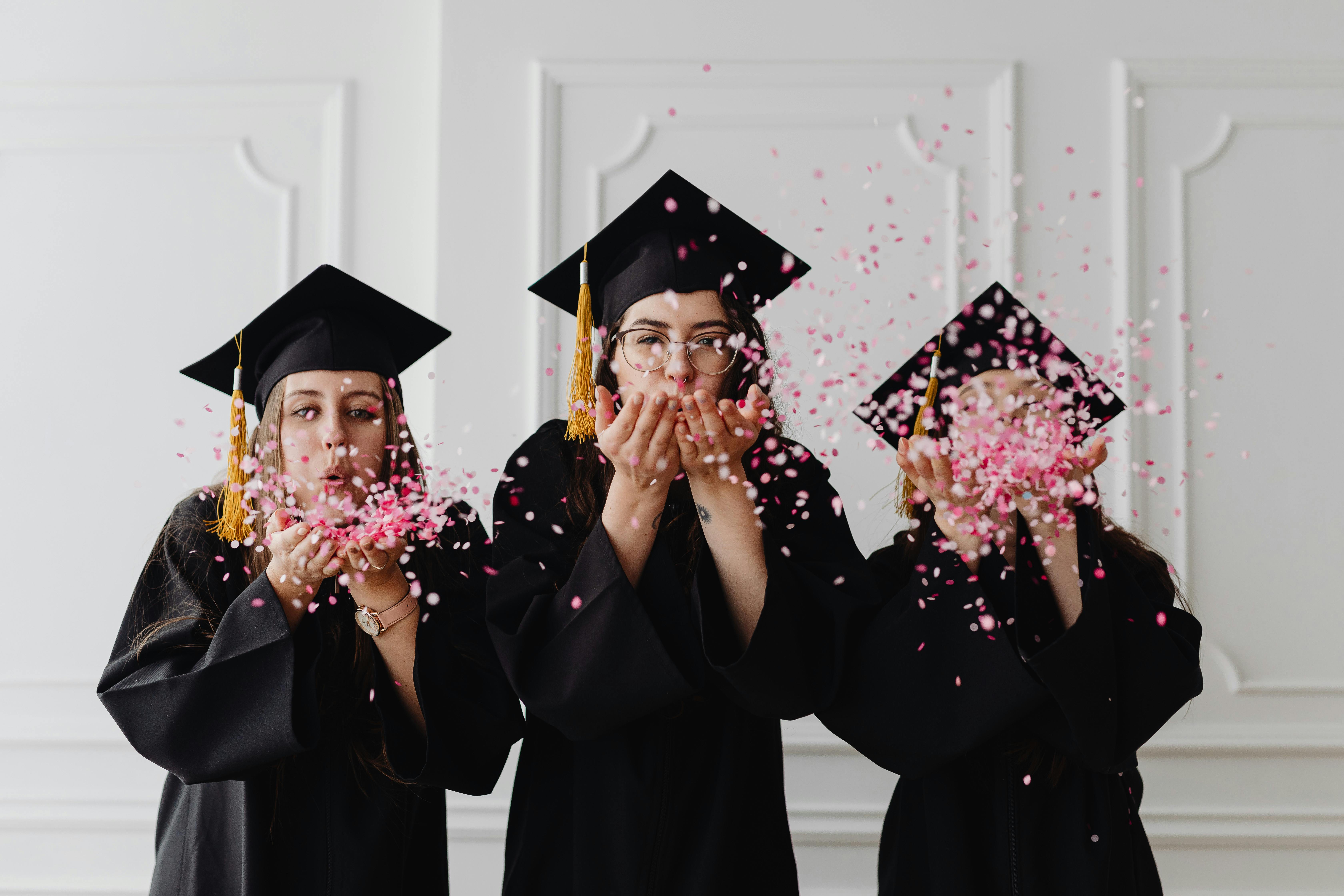 three-women-in-graduation-gowns-celebrate-by-blowing-confetti-indoors. - www.kaboompics.com (pexels)