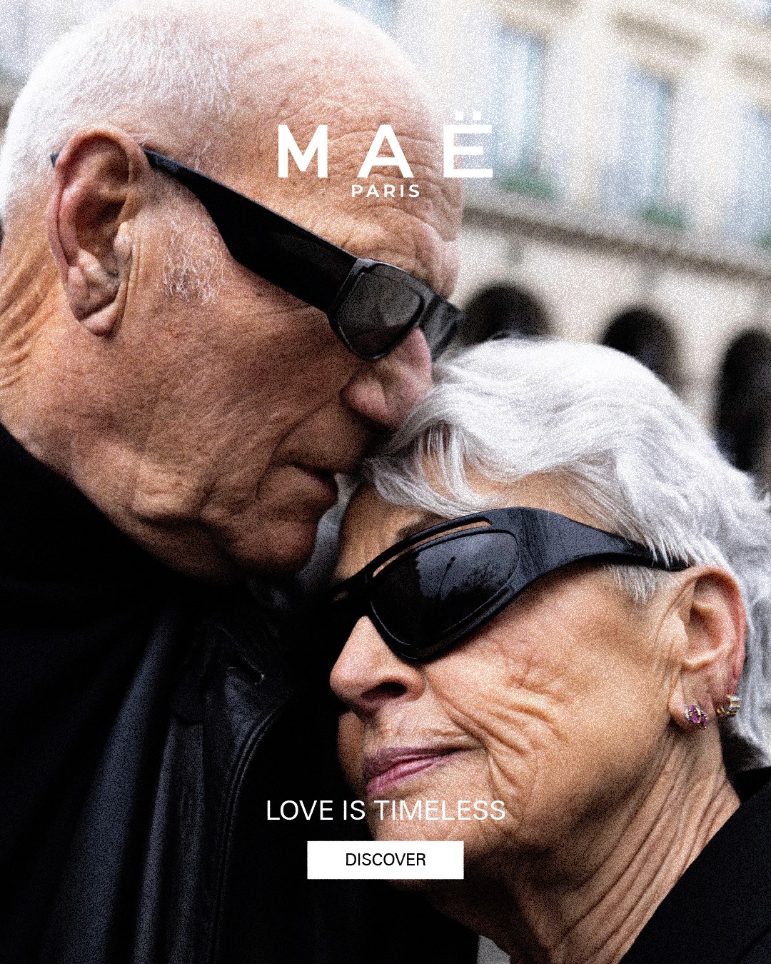 MAË PARIS luxury fashion campaign featuring an elderly couple wearing sunglasses expressing timeless love in Paris