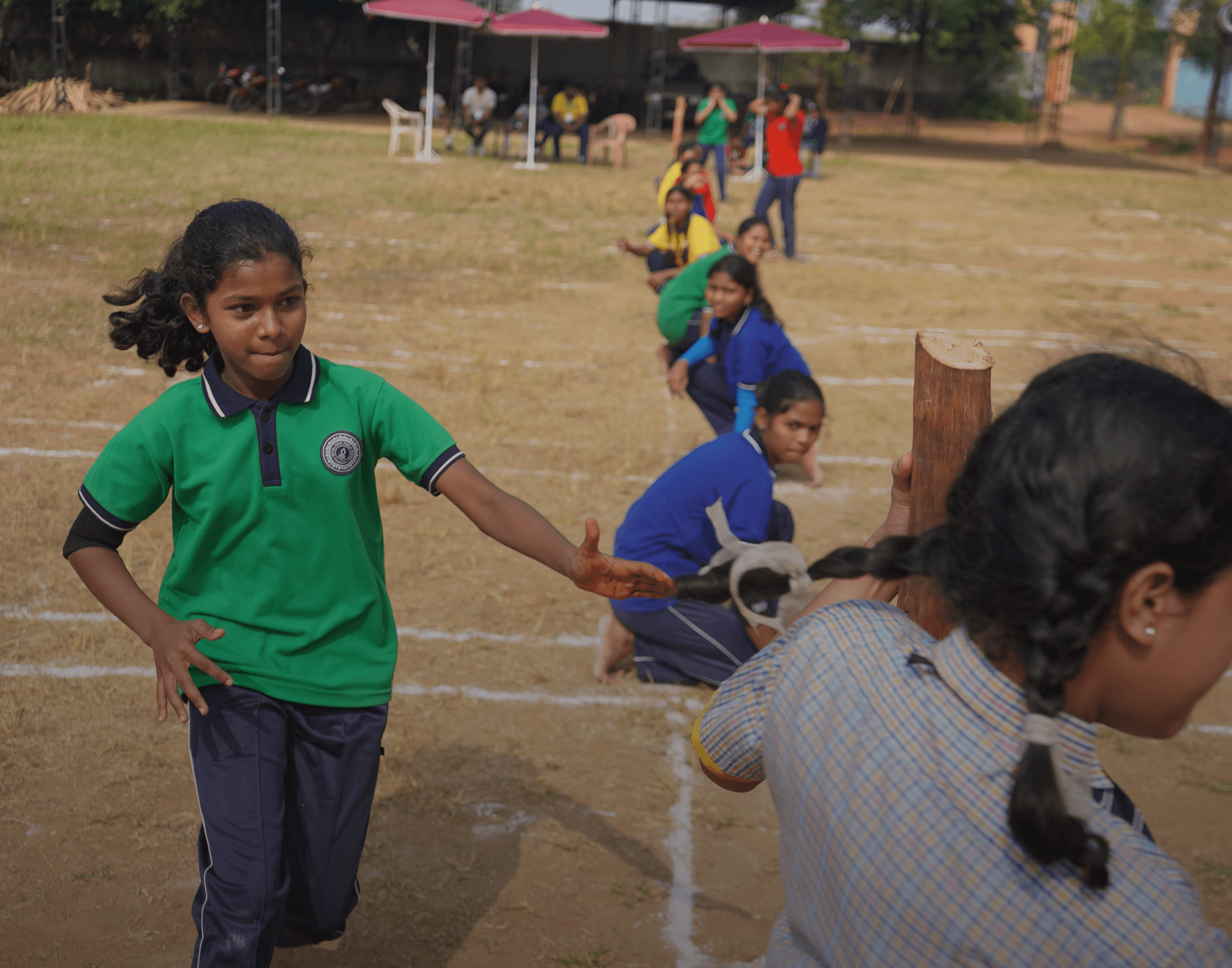 Two young boys race on a track.