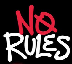 Young man with tousled brown hair and blue eyes, wearing a leaf-patterned shirt. Calm expression, indoor setting with blurred background.