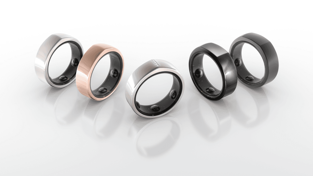 Black and white image of people working at a table with laptops, showing hands gesturing during discussion of digital content displayed on screens, with fabrica® logo in the corner.