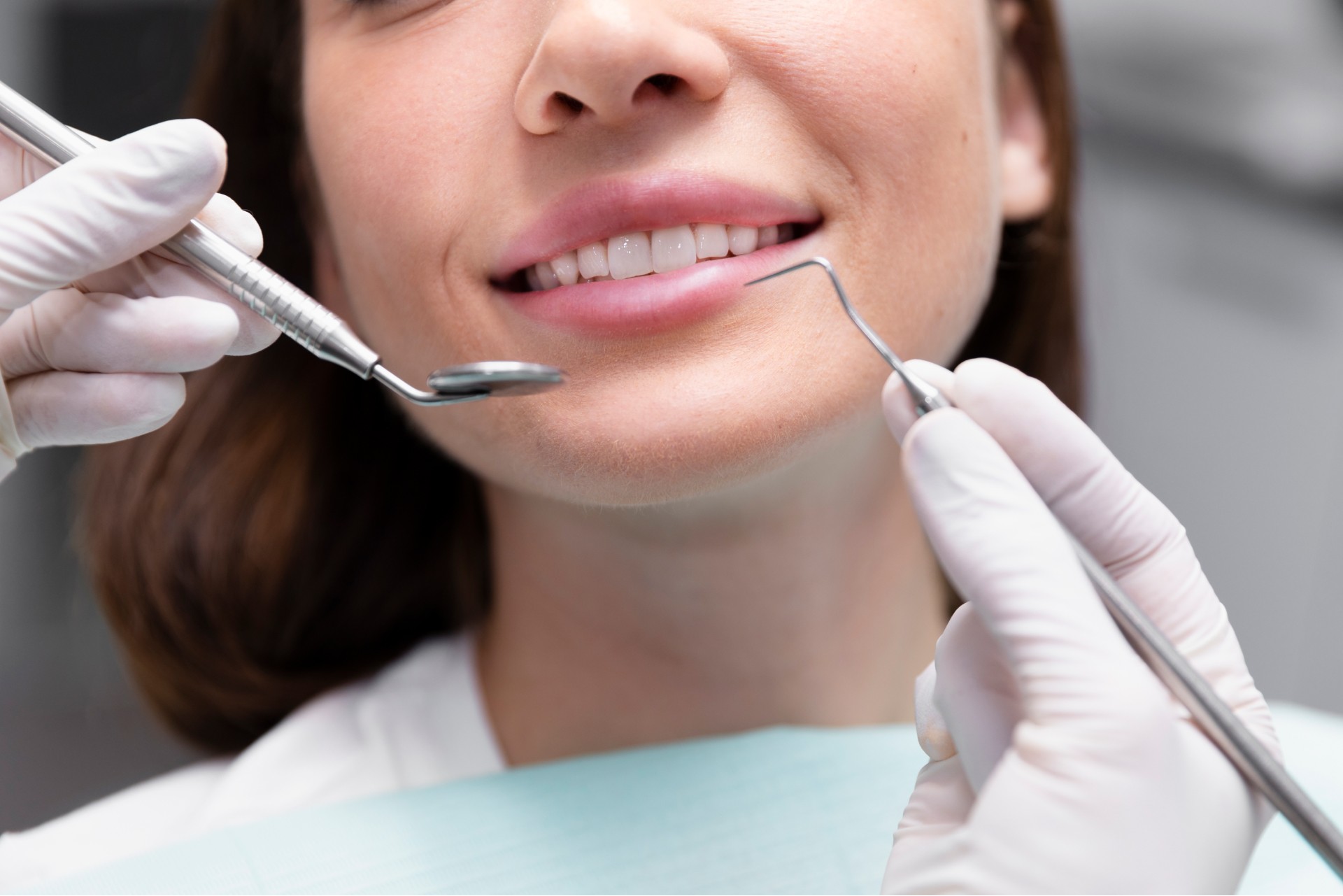 Close-up of a patient receiving a dental checkup with professional tools.