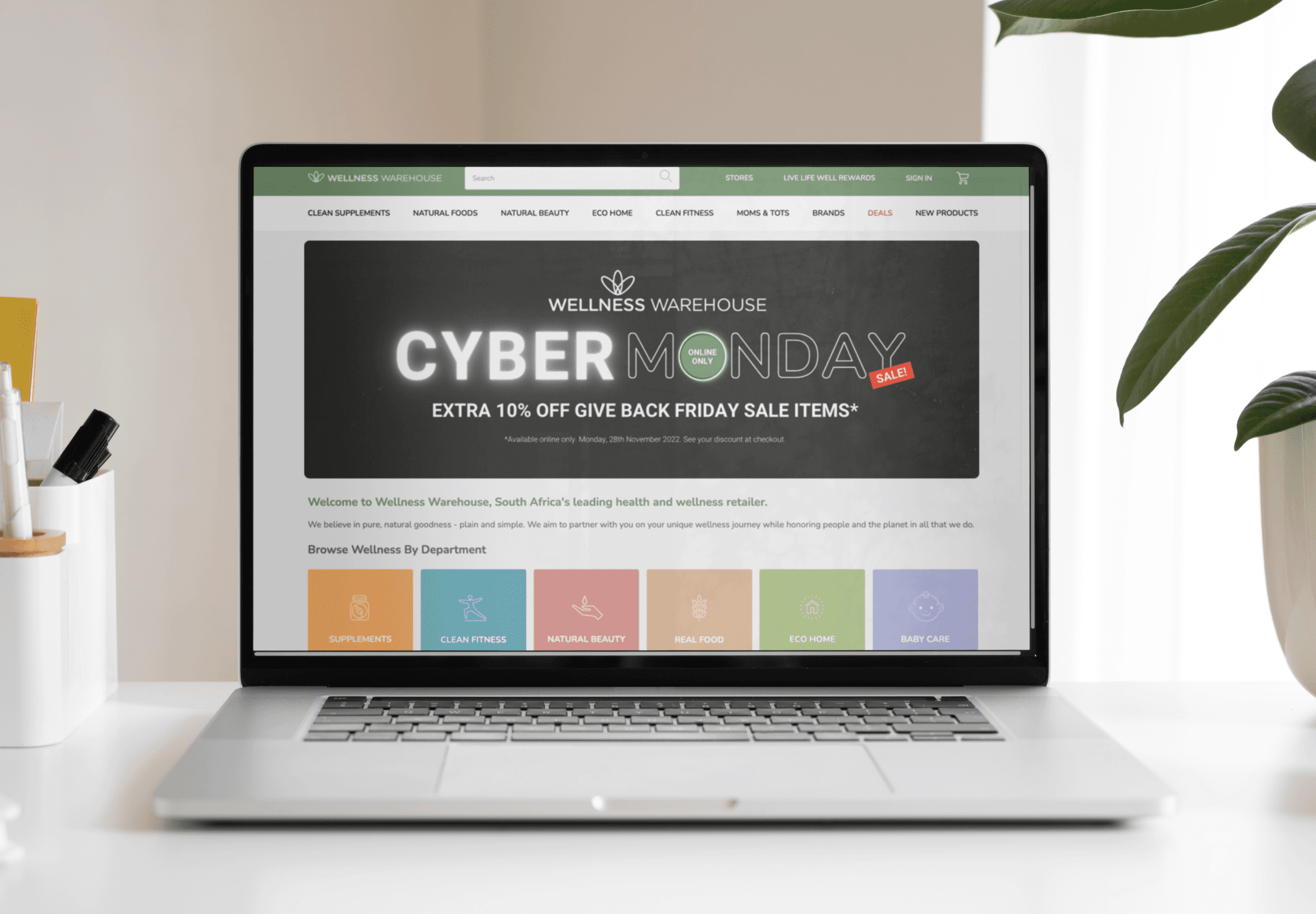 laptop screen showing Wellness Warehouse Cyber Monday graphics