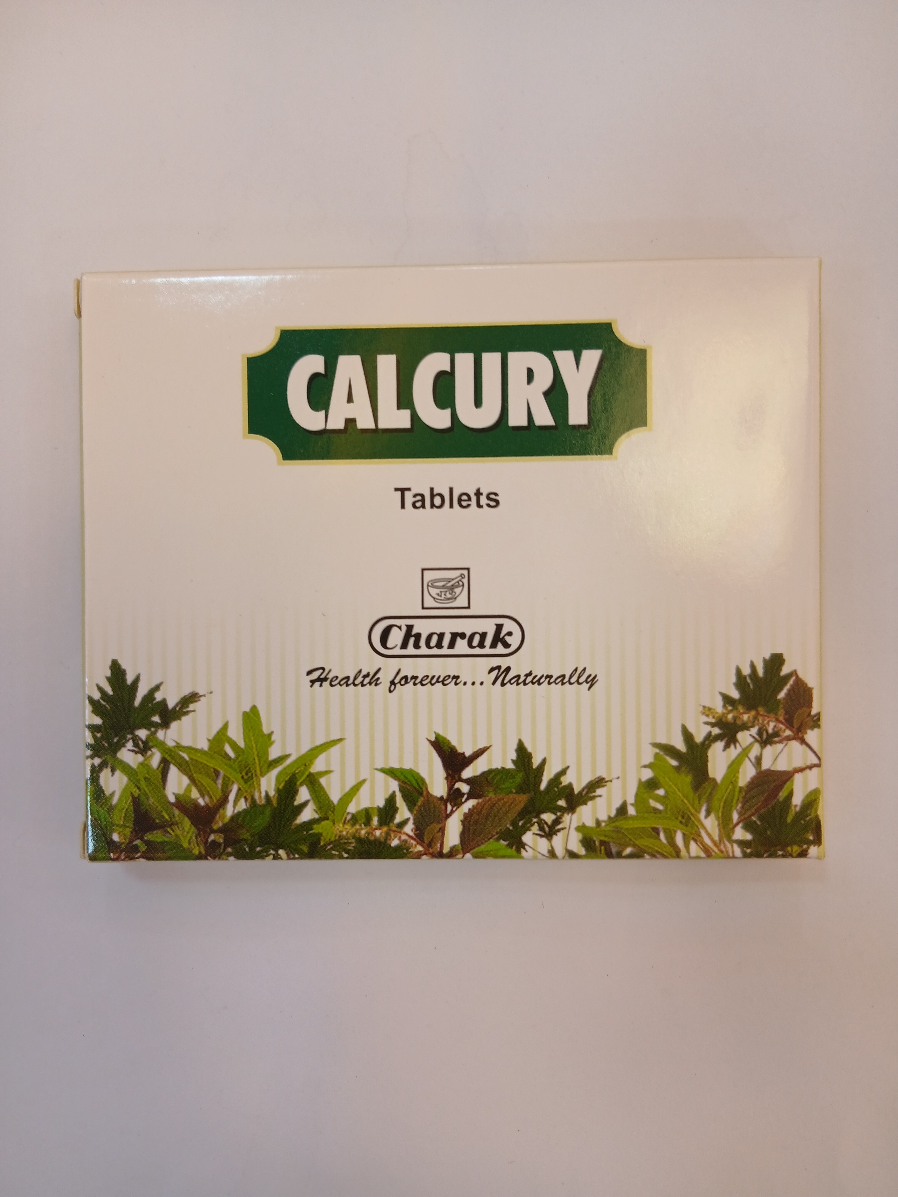 White cardboard packaging displays green and white printed text reading "Tablets" within a green banner at the top, with the brand name and slogan "Health power... Naturally" below, framed by illustrations of green plants and leaves.