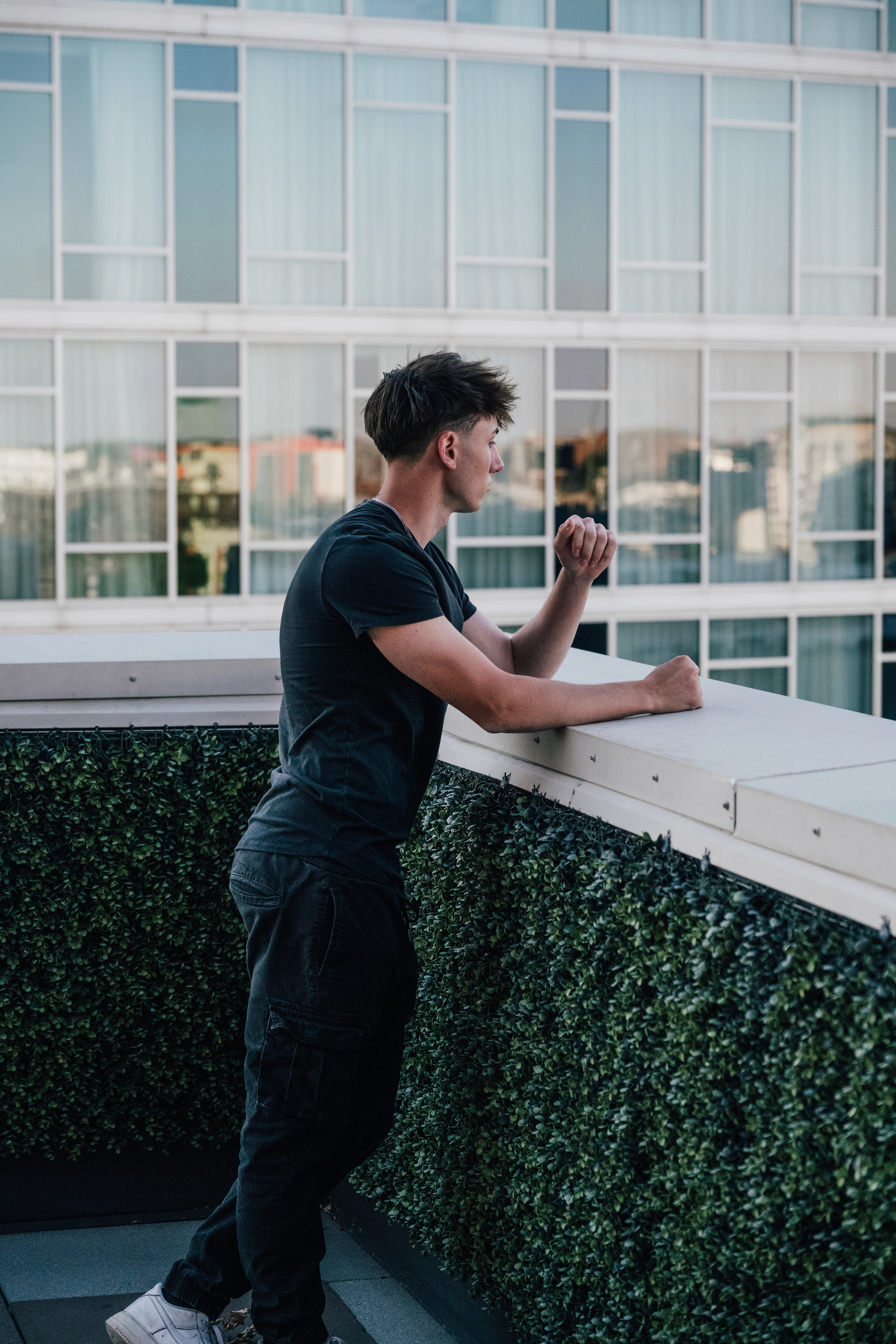 Ezra Urmy standing on balcony