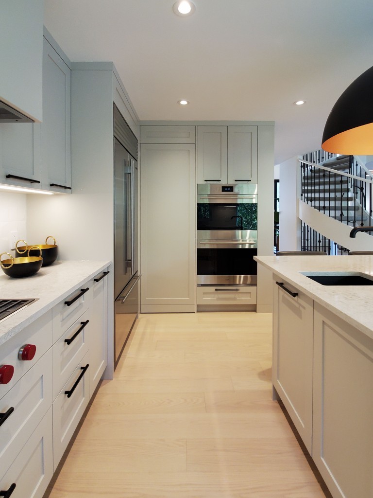 Image of Luxury kitchen design by KHD Homes featuring white cabinets, marble countertops, and stainless steel appliances.
