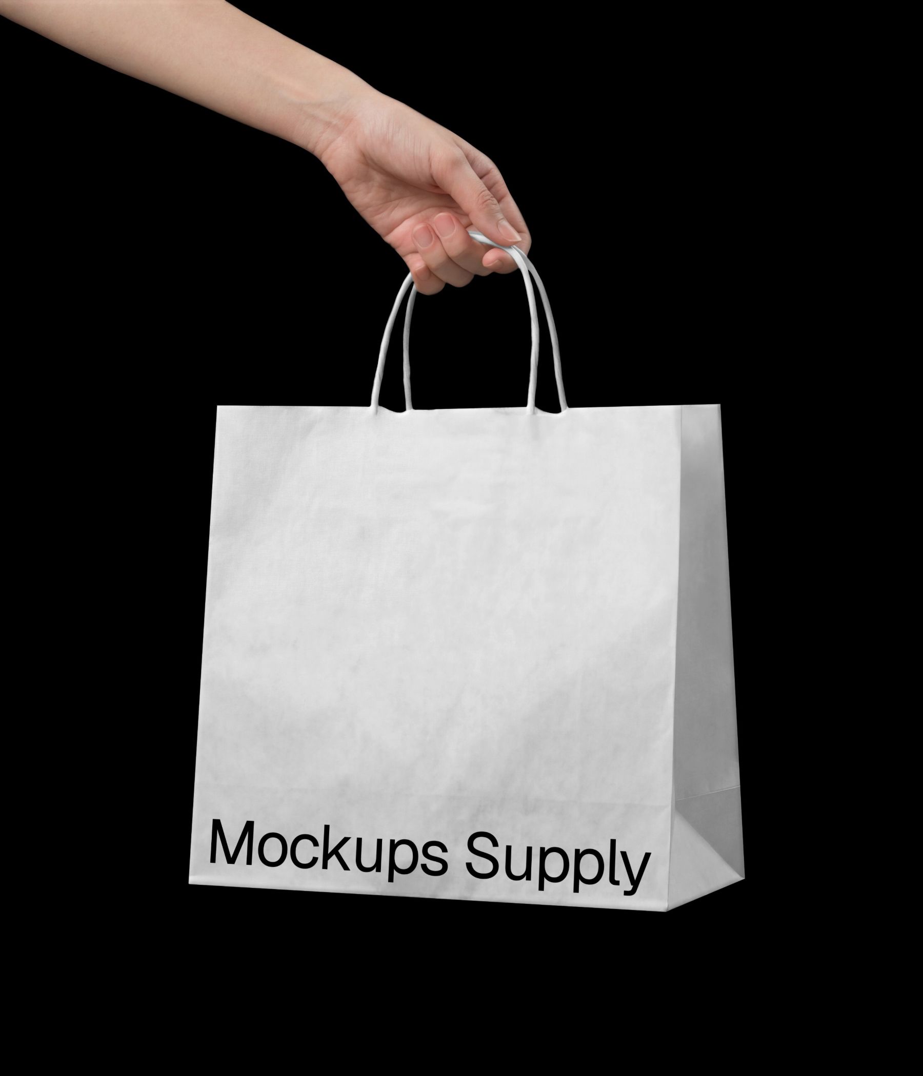 Hand holding paper bag mockup with twisted handle download PSD